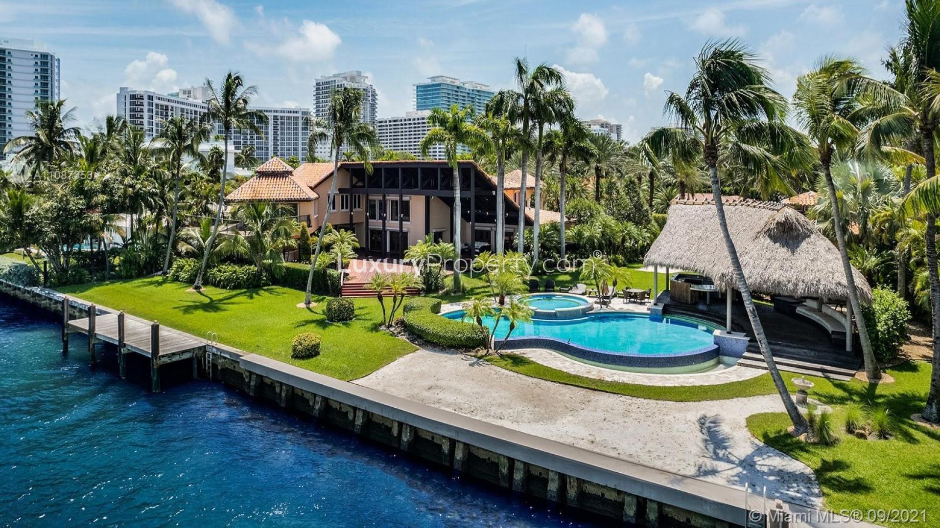 Bayfront villa with private dock, lush greenery, and scenic water views in Miami, Florida