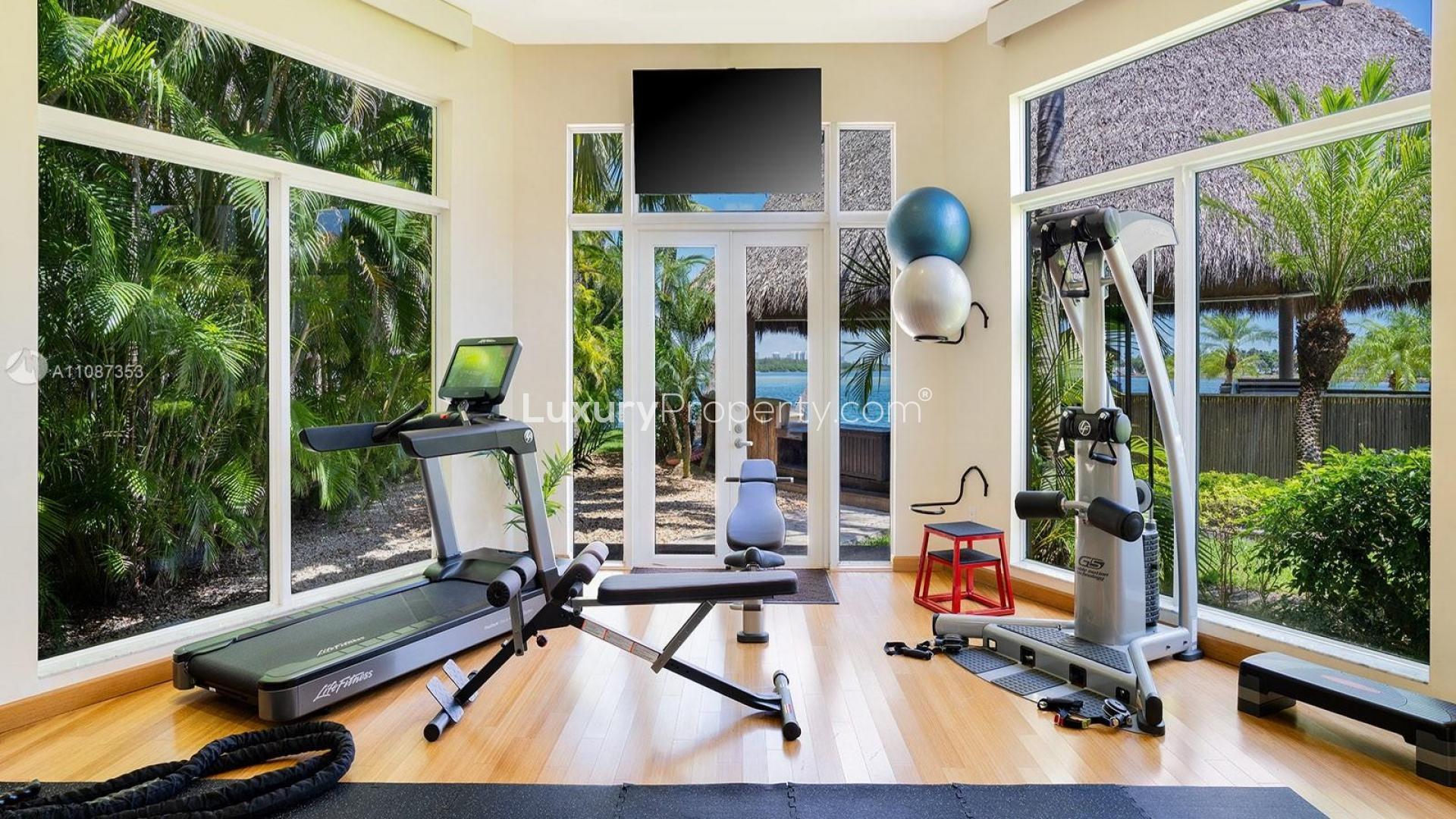 Bayfront villa with lush gardens, pool, and dock at 276 Bal Bay Dr, Miami