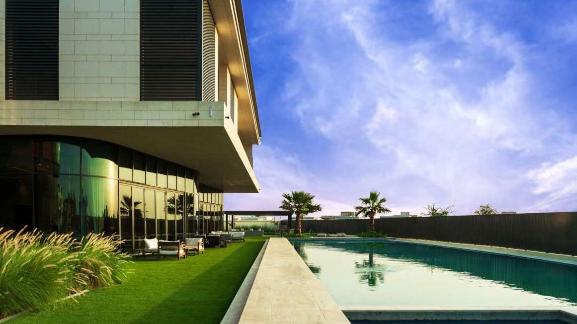 Luxurious 9-bedroom villa exterior in Dubai Hills View, modern architecture, gated entrance