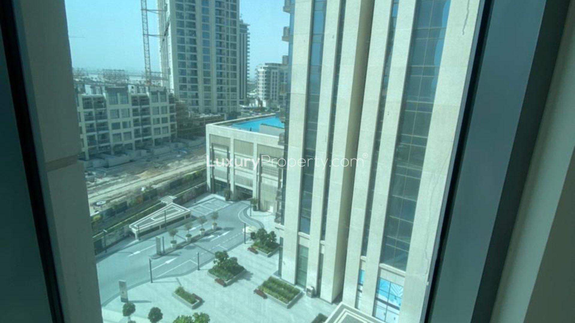 Balcony view of construction and cityscape in Dubai Creek Harbour apartment for sale