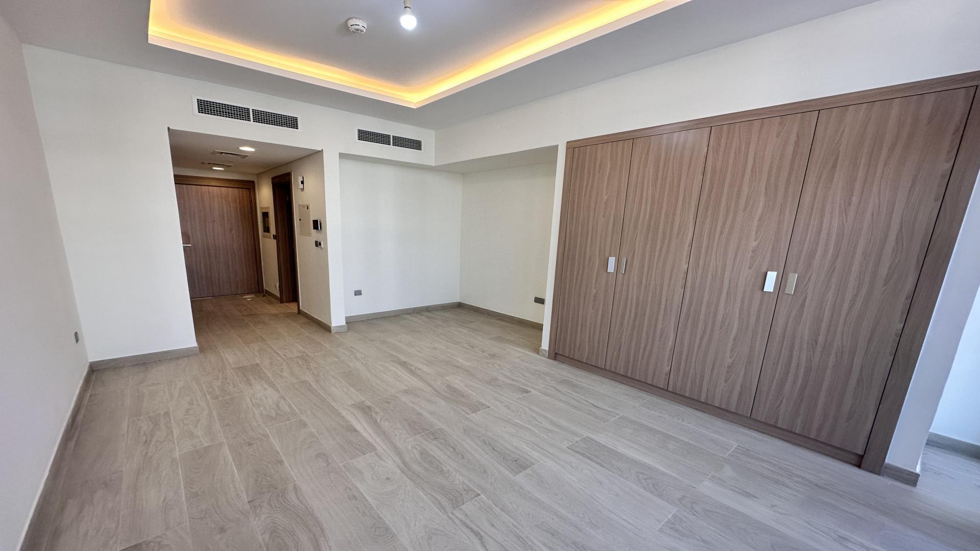 Modern studio apartment interior with large windows in Azizi Riviera, Meydan One, Dubai