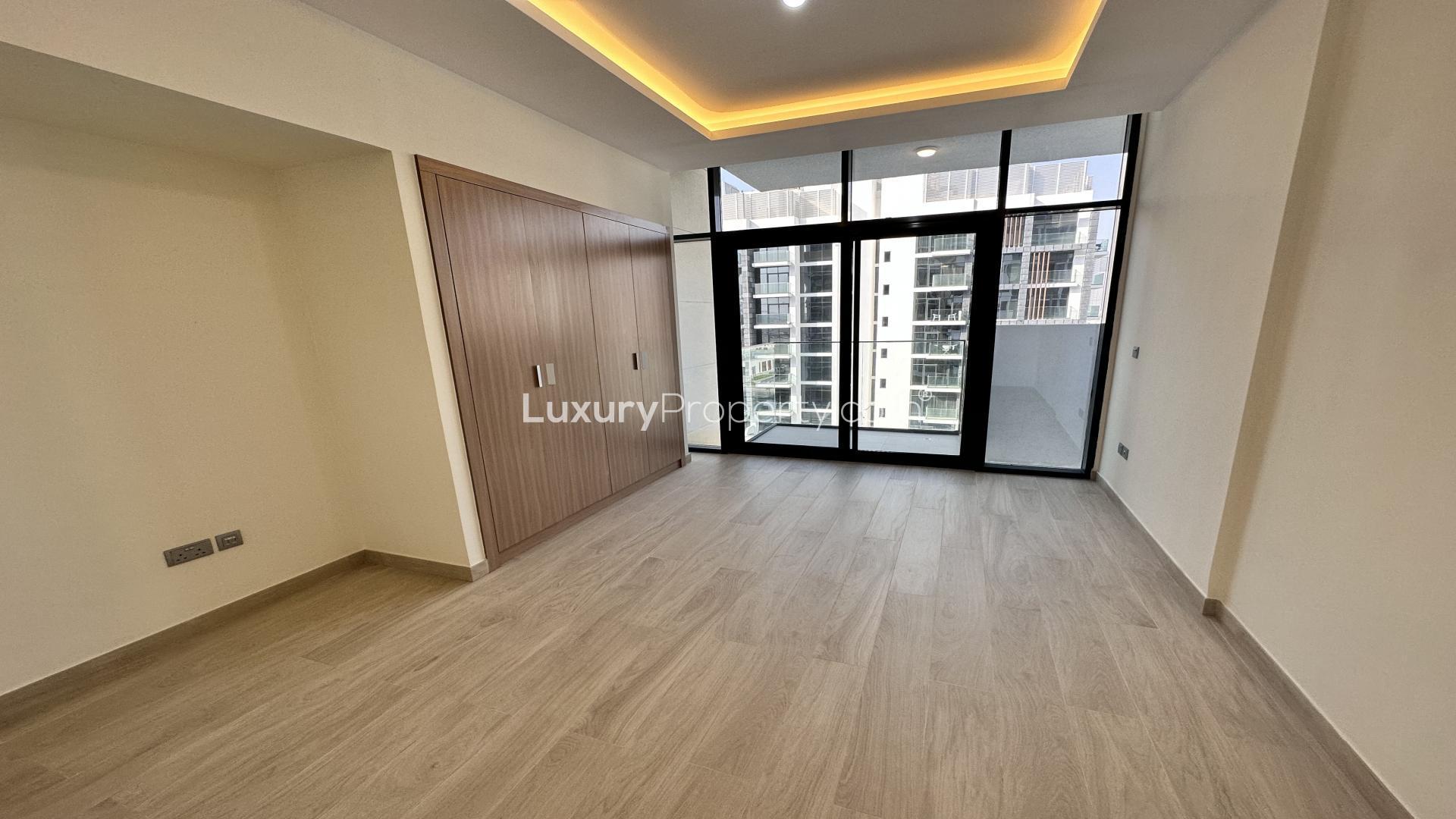 Modern kitchen in Azizi Riviera Meydan studio apartment, featuring sleek cabinets and appliances