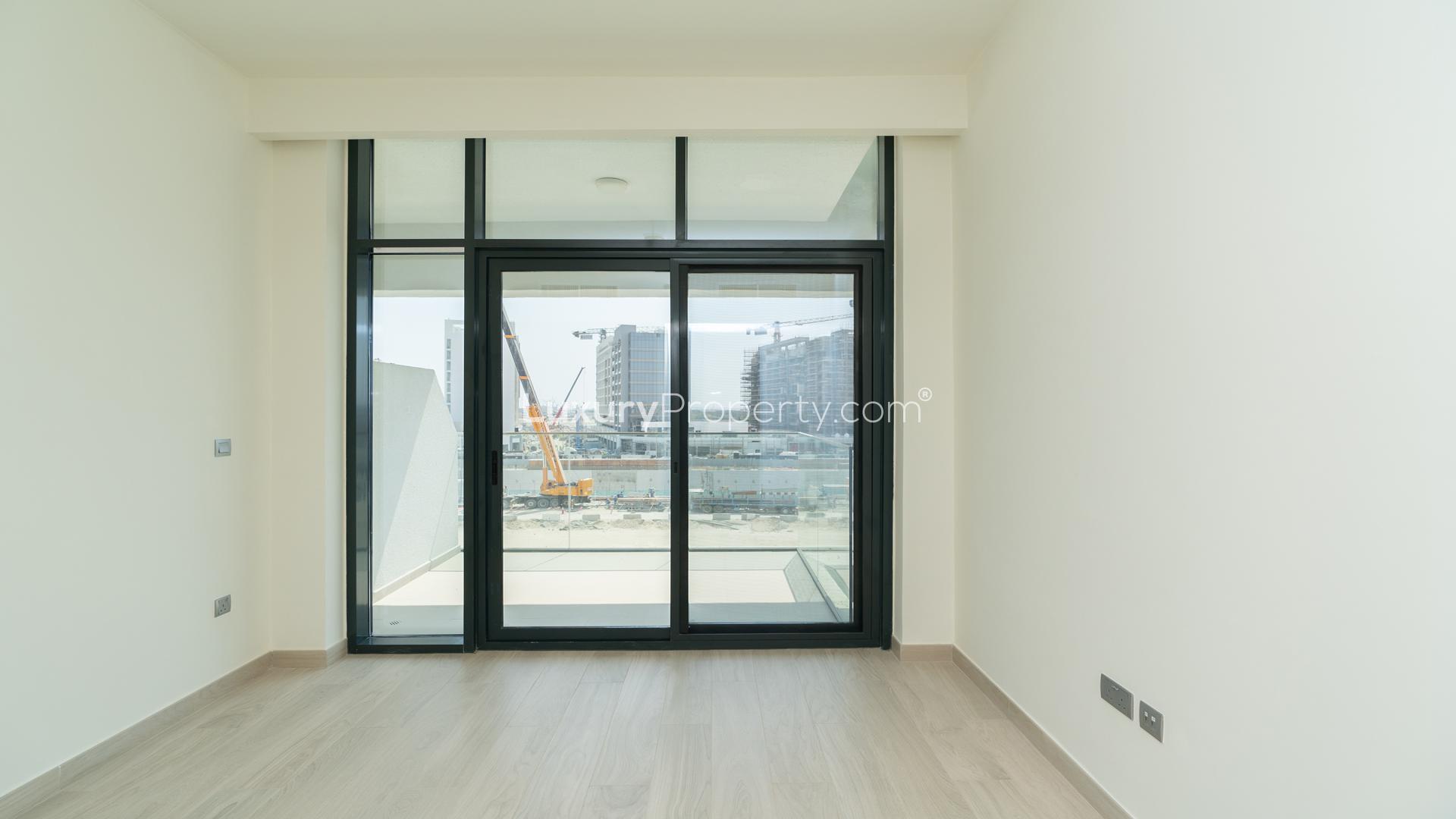Elegant studio interior with large window at Azizi Riviera, Meydan One, Dubai