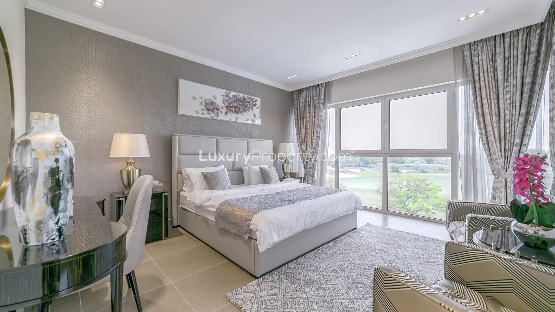 Luxurious villa exterior at Sienna Views, Jumeirah Golf Estates, with garden and driveway