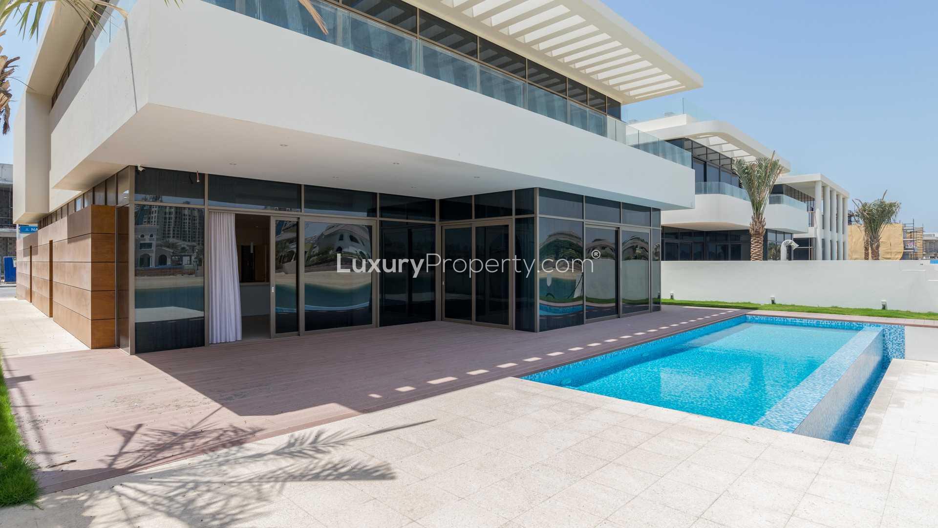 Luxurious villa interior with waterfront view, large windows, and modern design on Palm Jumeirah
