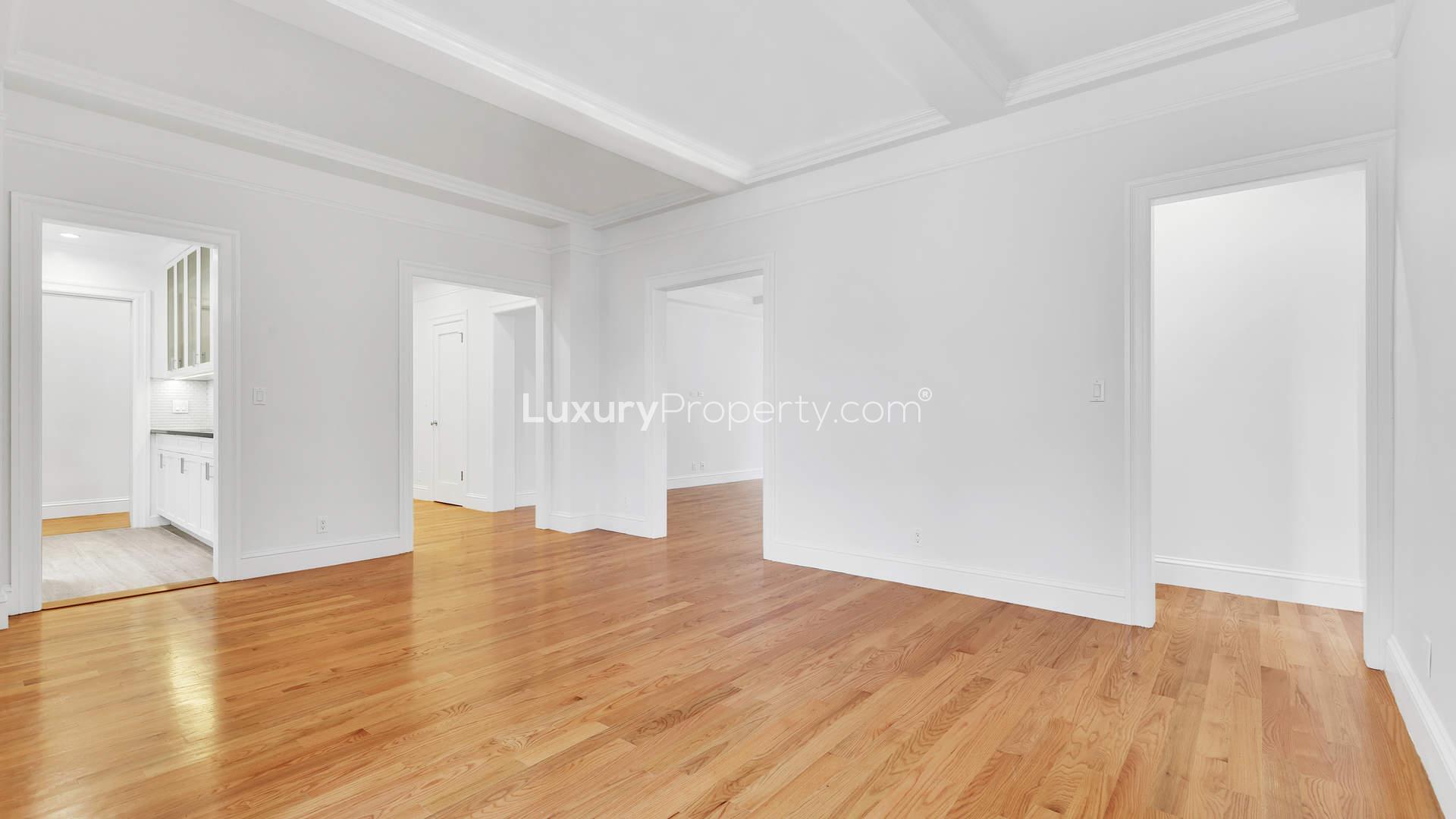 Modern kitchen in Manhattan apartment with sleek cabinetry and city view windows