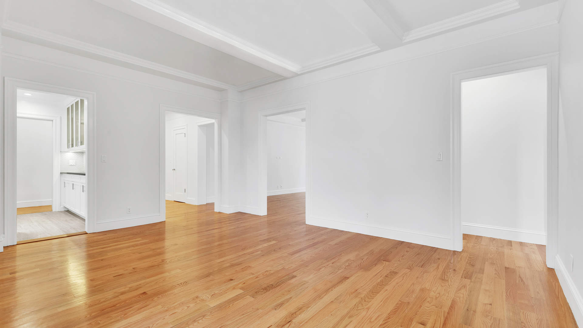 Modern kitchen in Manhattan apartment with sleek cabinetry and city view windows