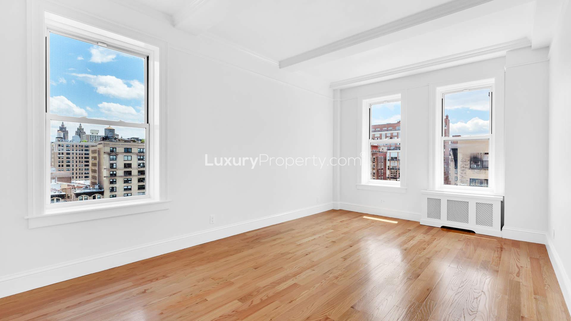 "Red brick apartment building on West End Avenue, Manhattan, New York for sale.",Bright living room with hardwood floors, large windows, city view, West End Avenue apartment