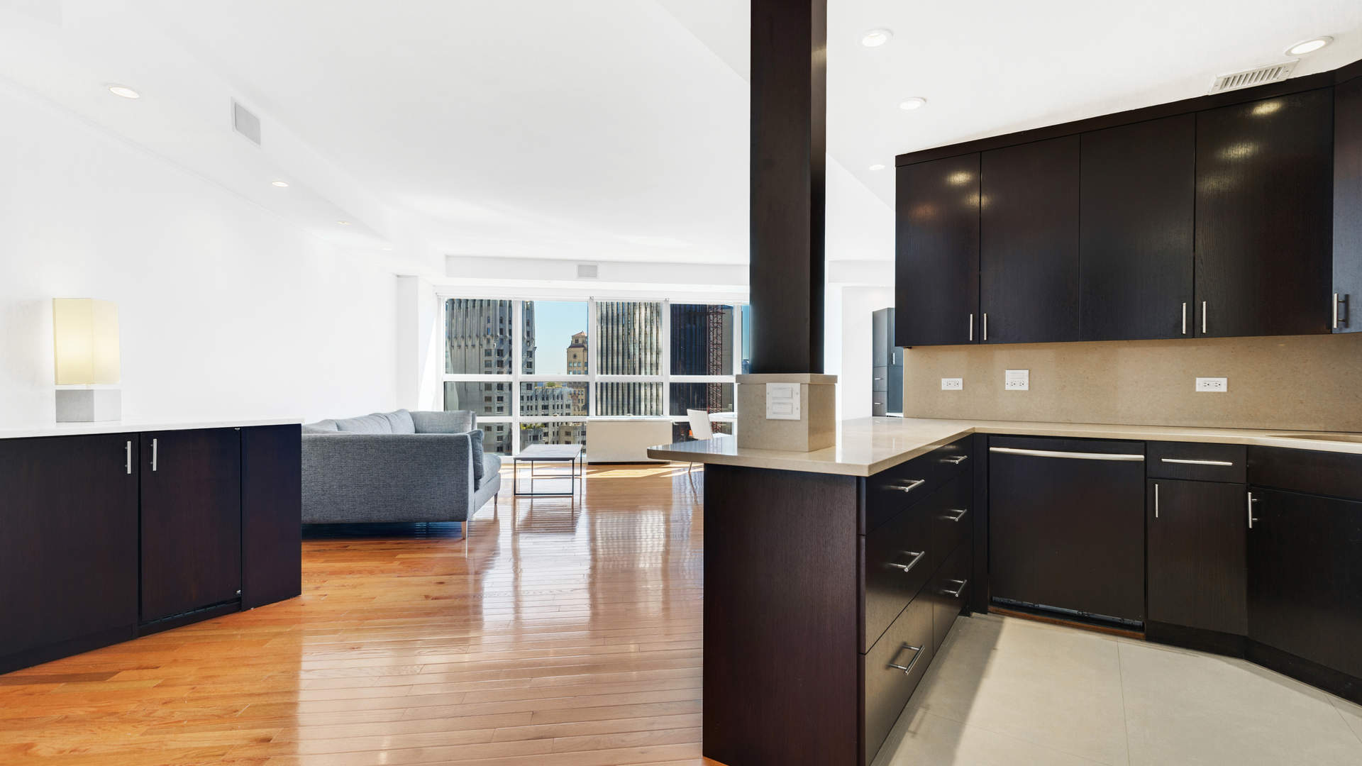 Stylish Manhattan one-bedroom apartment with city view, modern furnishings, and built-in shelving