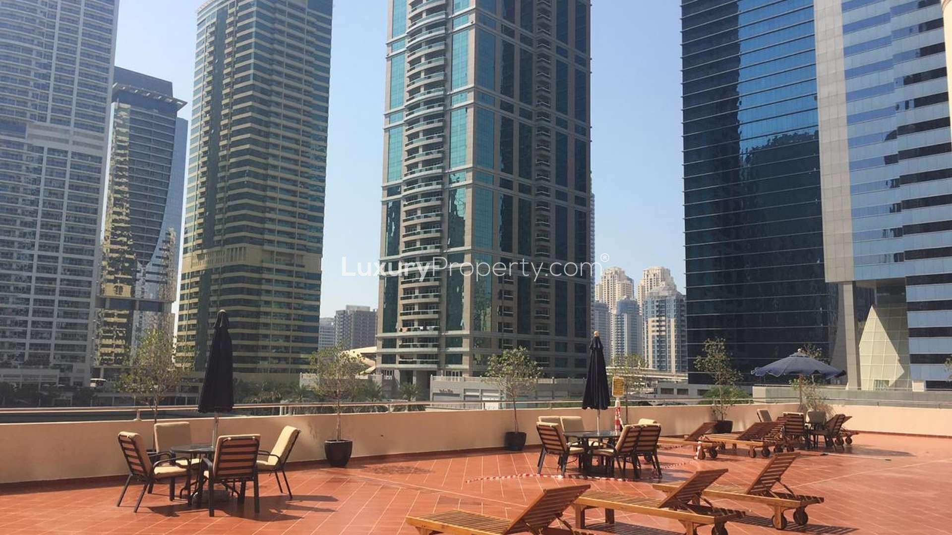 View from penthouse window overlooking Jumeirah Lake Towers skyline in Dubai Arch Tower