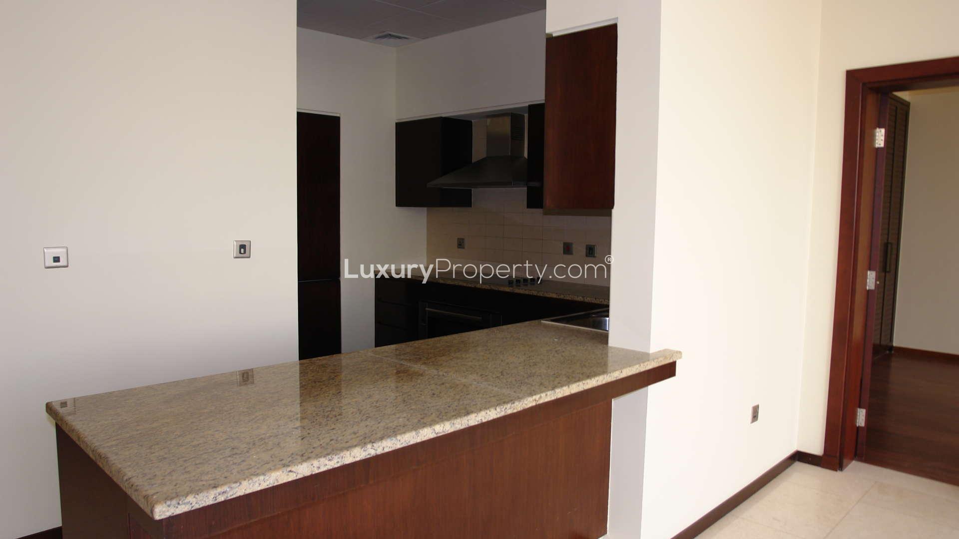 Modern kitchen and living area in Tiara Residence apartment, Palm Jumeirah, for rent