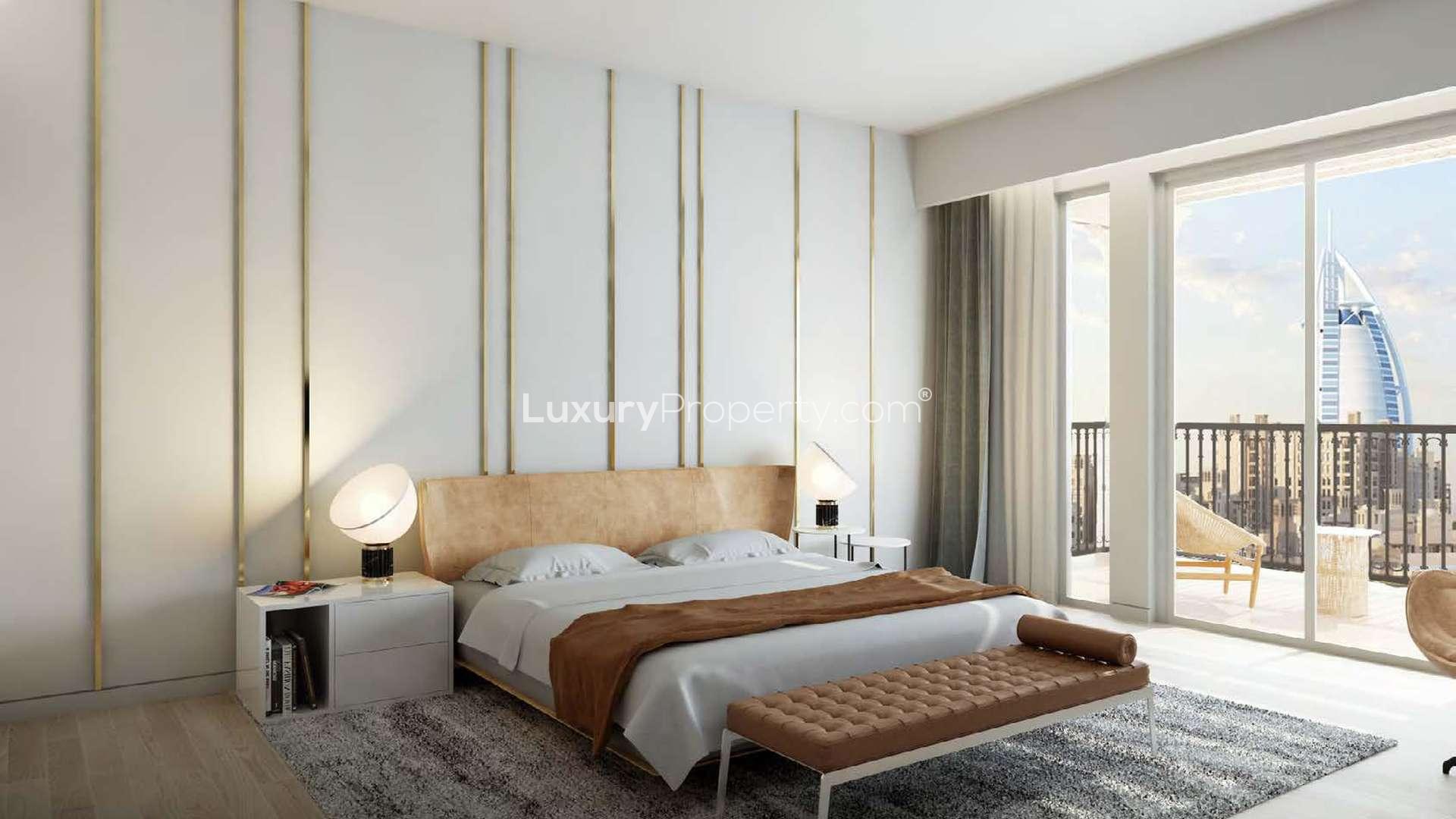Alt text: "Scenic view of Asayel apartments and gardens in Madinat Jumeirah Living, Umm Suqeim.",Luxurious bedroom with balcony view at Asayel, Madinat Jumeirah Living apartment for sale