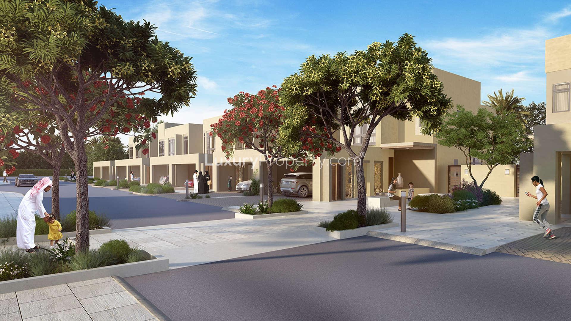 Pathway view in Noor Townhouses, Town Square, surrounded by lush greenery and modern architecture