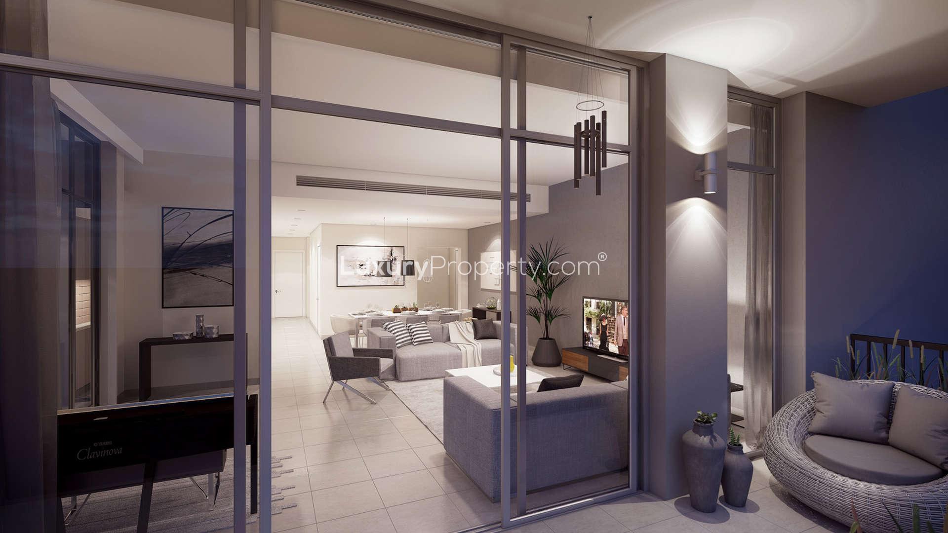 Elegant Jenna Apartments exterior with palm-lined street in Dubai Town Square community