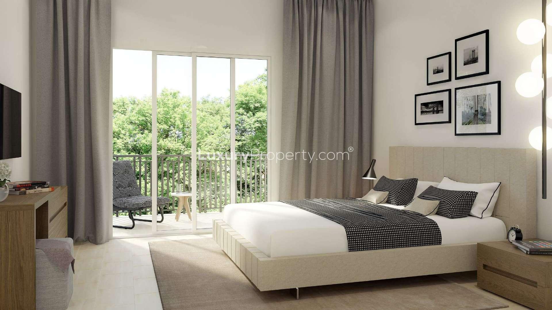 Modern bedroom in Safi Townhouses, Dubai Town Square with balcony view and stylish decor