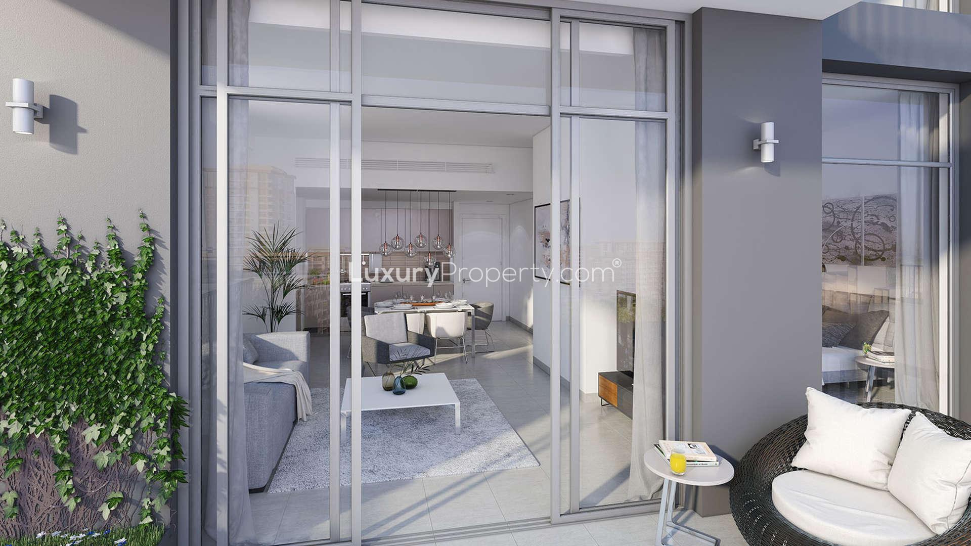 Modern living room and balcony view in Warda Apartments, Dubai Town Square residence