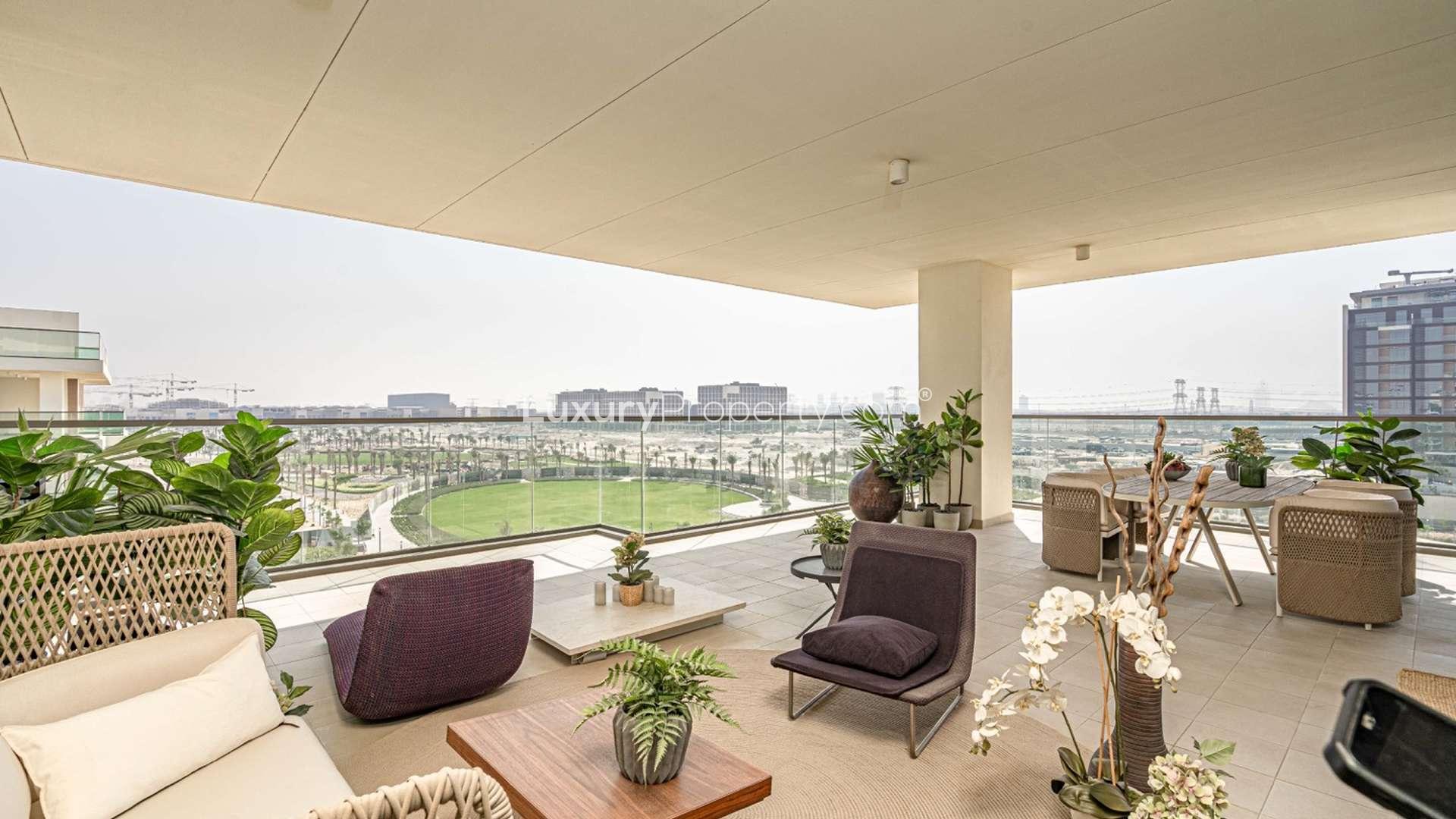 Elegant balcony at Mulberry apartment, Dubai Hills Estate, featuring modern outdoor seating and greenery