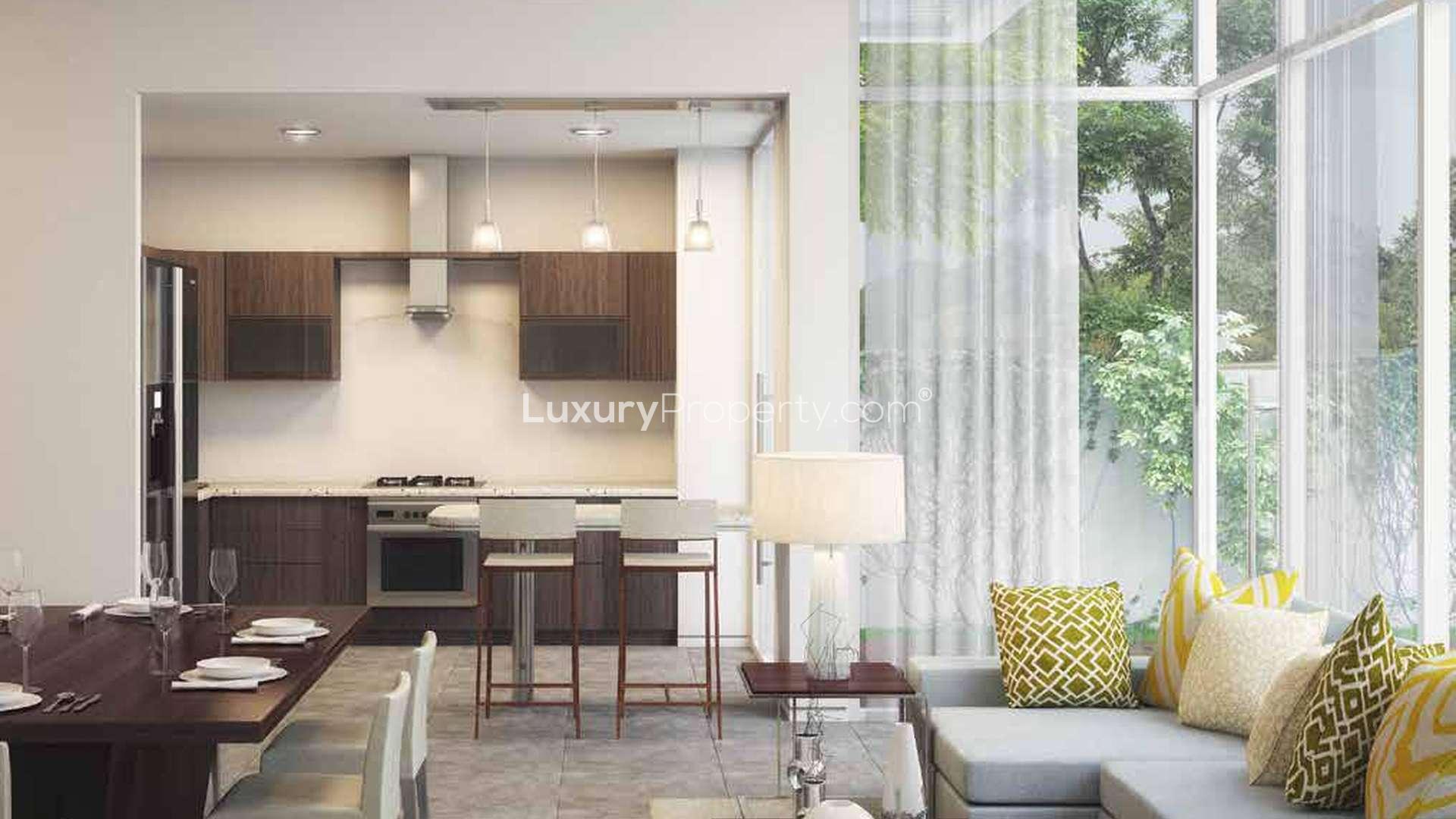 Modern two-bedroom townhouse exterior in Arabella II, Mudon, with lush garden view