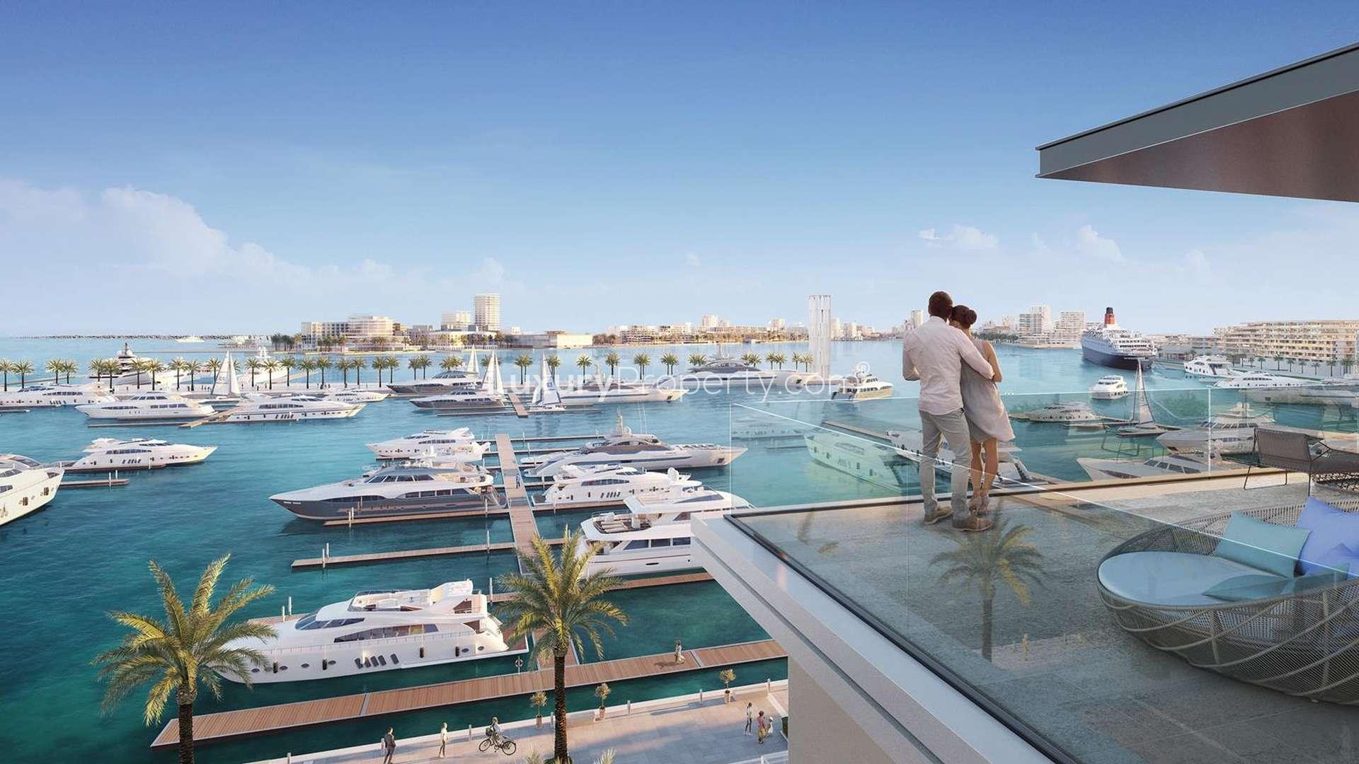 Contemporary waterfront apartment buildings in Mina Rashid, Sirdhana, with yachts and palm trees