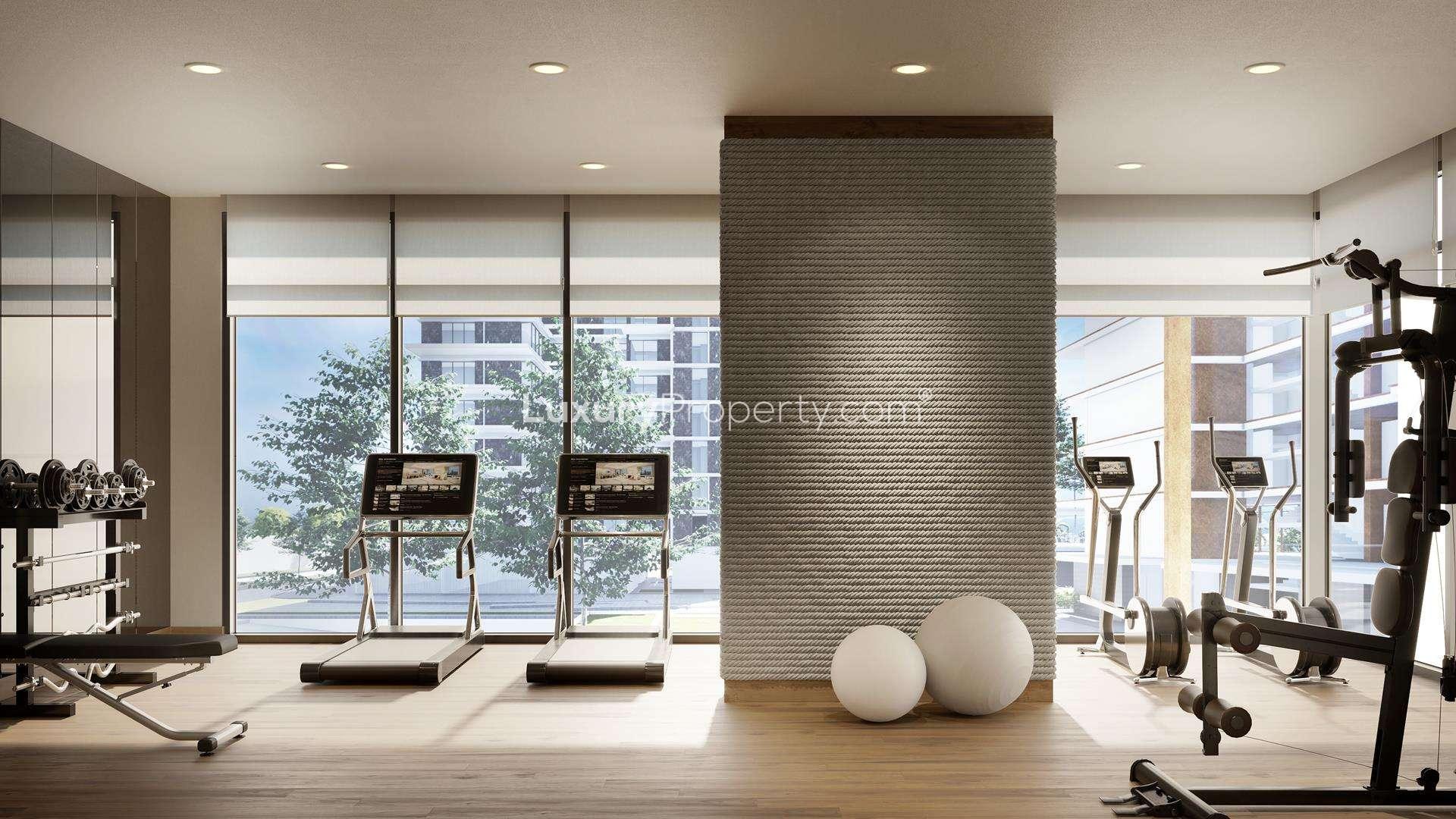 Luxury Mina Rashid apartment gym with modern equipment and large windows