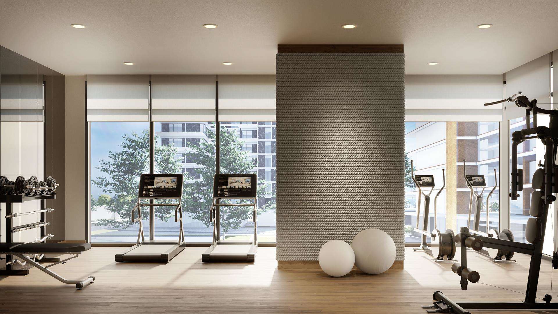 Luxury Mina Rashid apartment gym with modern equipment and large windows
