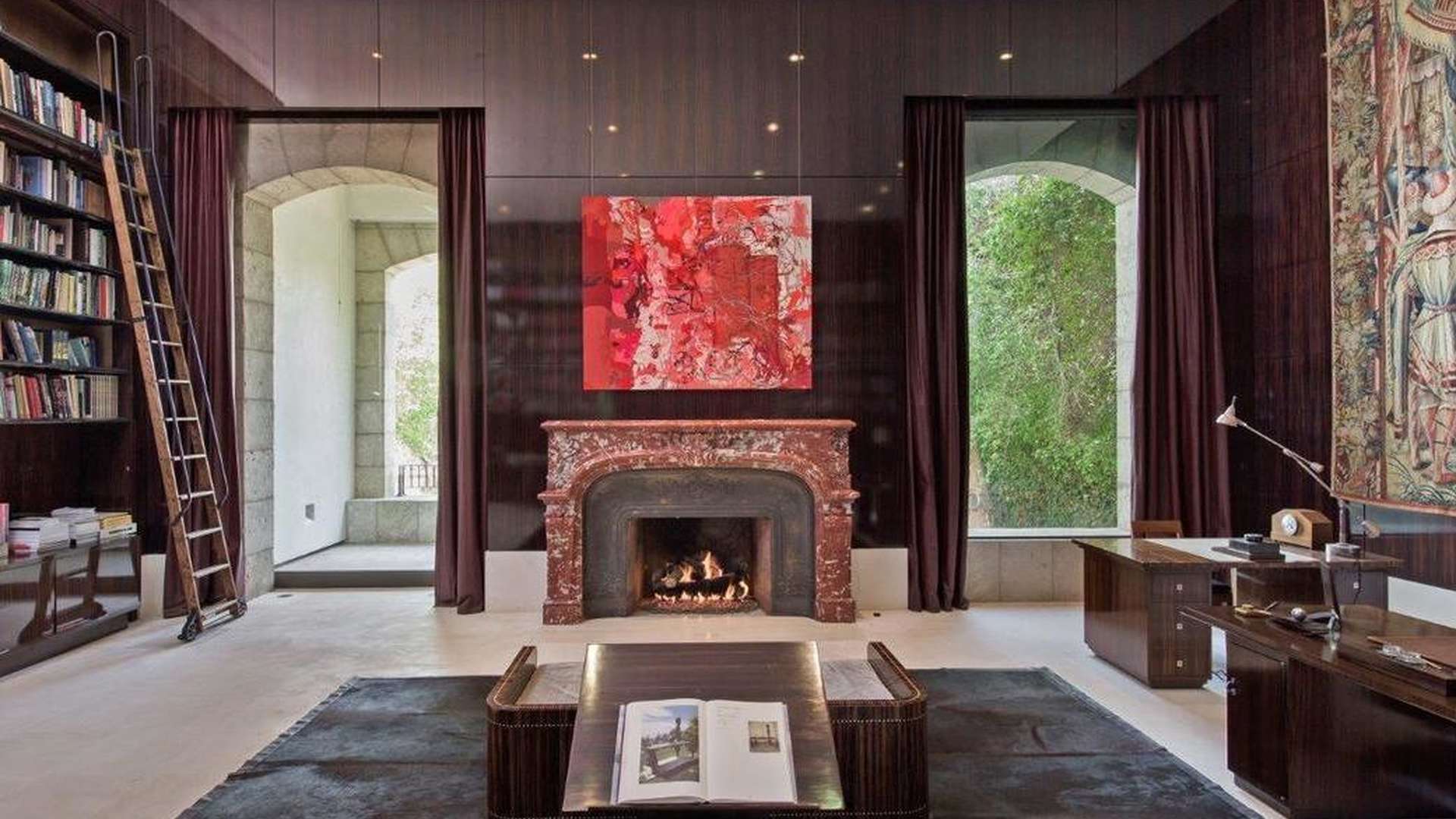 Luxurious living room with high ceilings, fireplace, and grand piano in Holmby Hills villa