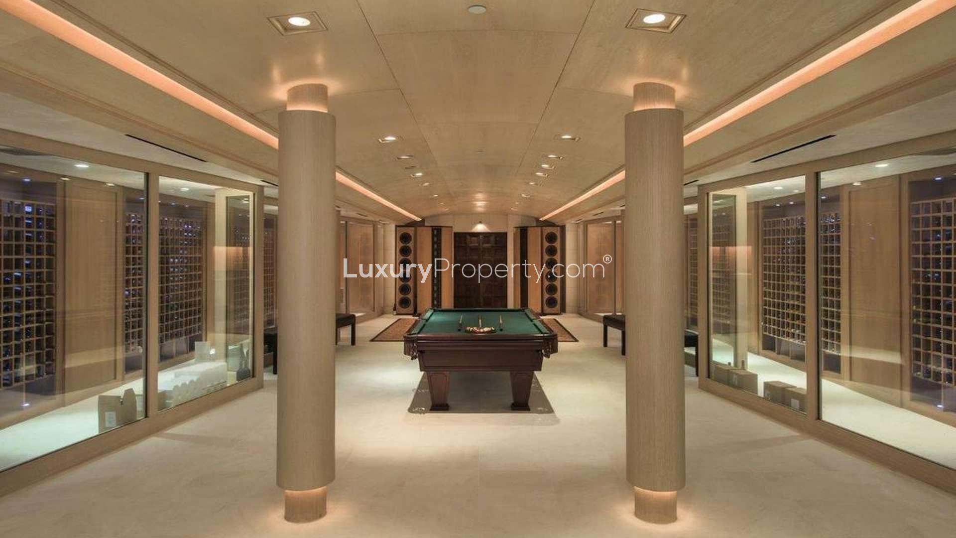 Luxurious Holmby Hills villa interior with fireplace, art, and bookshelves, Los Angeles