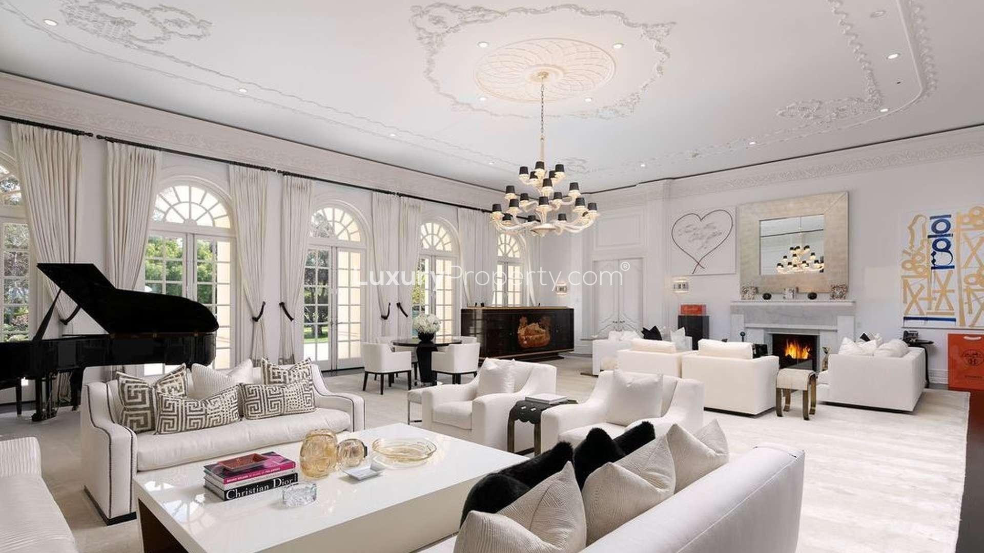 Aerial view of luxurious 15-bedroom villa with pool at 594 S Mapleton Dr, Los Angeles