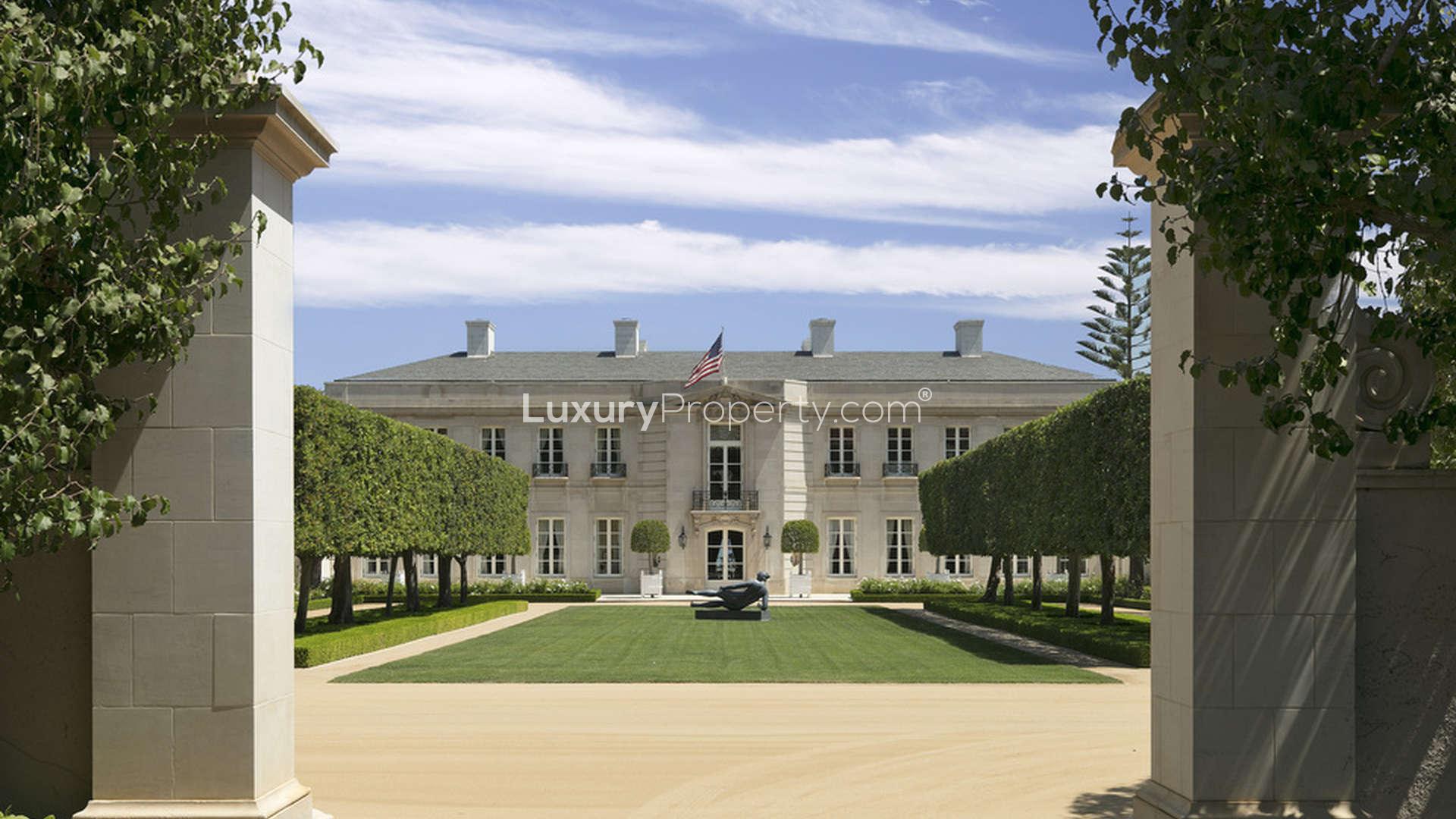 Aerial view of Chartwell estate villa, lush gardens, Los Angeles skyline in background