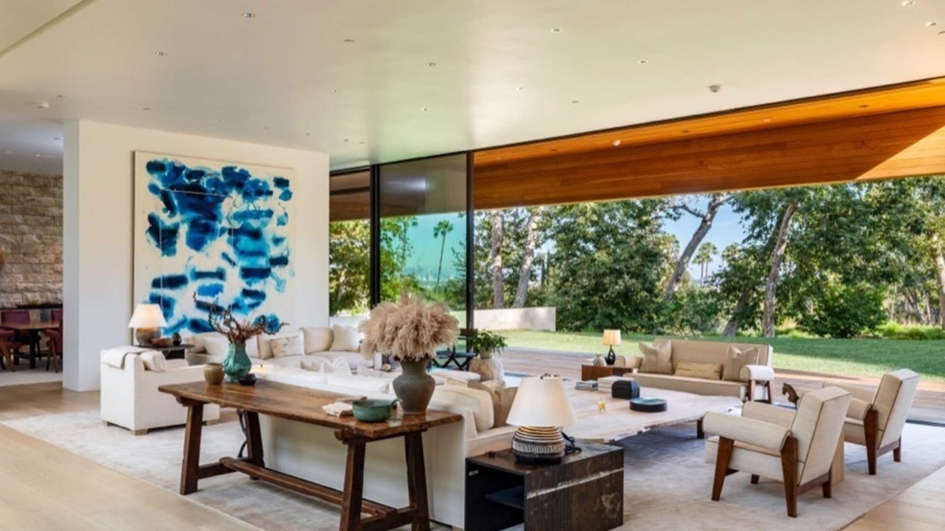 Contemporary villa living room with modern decor, large windows, and garden view in Beverly Hills