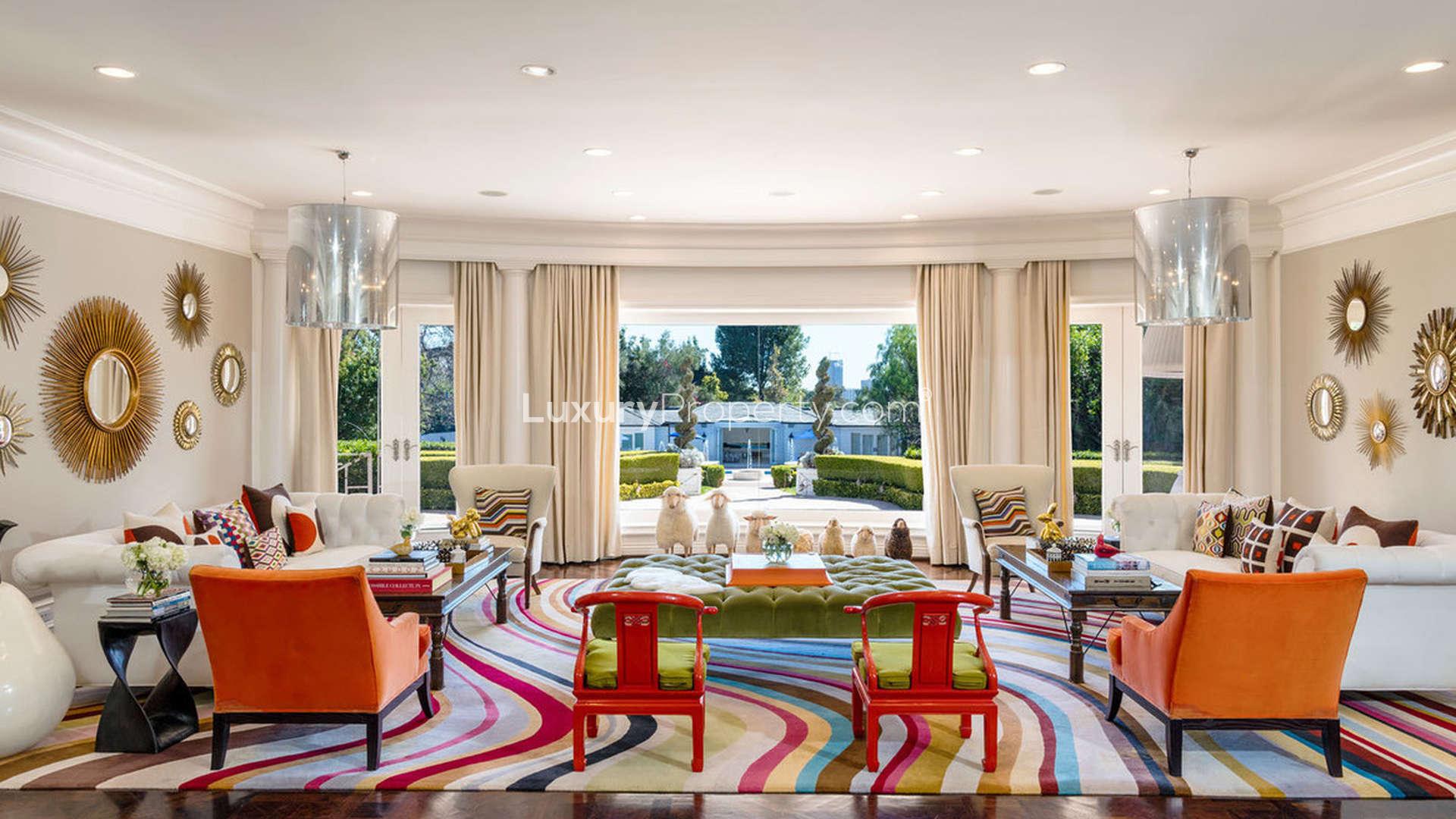 Grand foyer with dual staircase and chandelier, Holmby Hills villa, Los Angeles