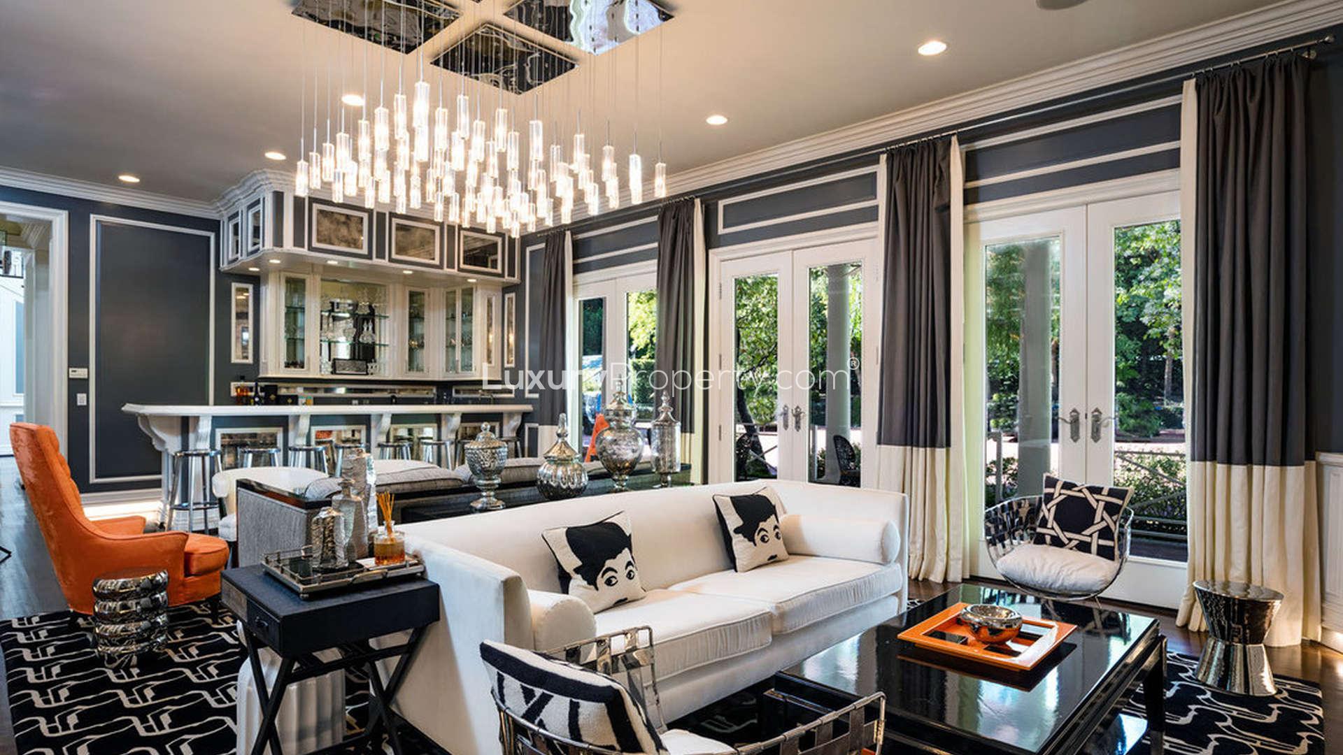 Luxurious living room in Holmby Hills villa, vibrant decor, garden view, spacious seating