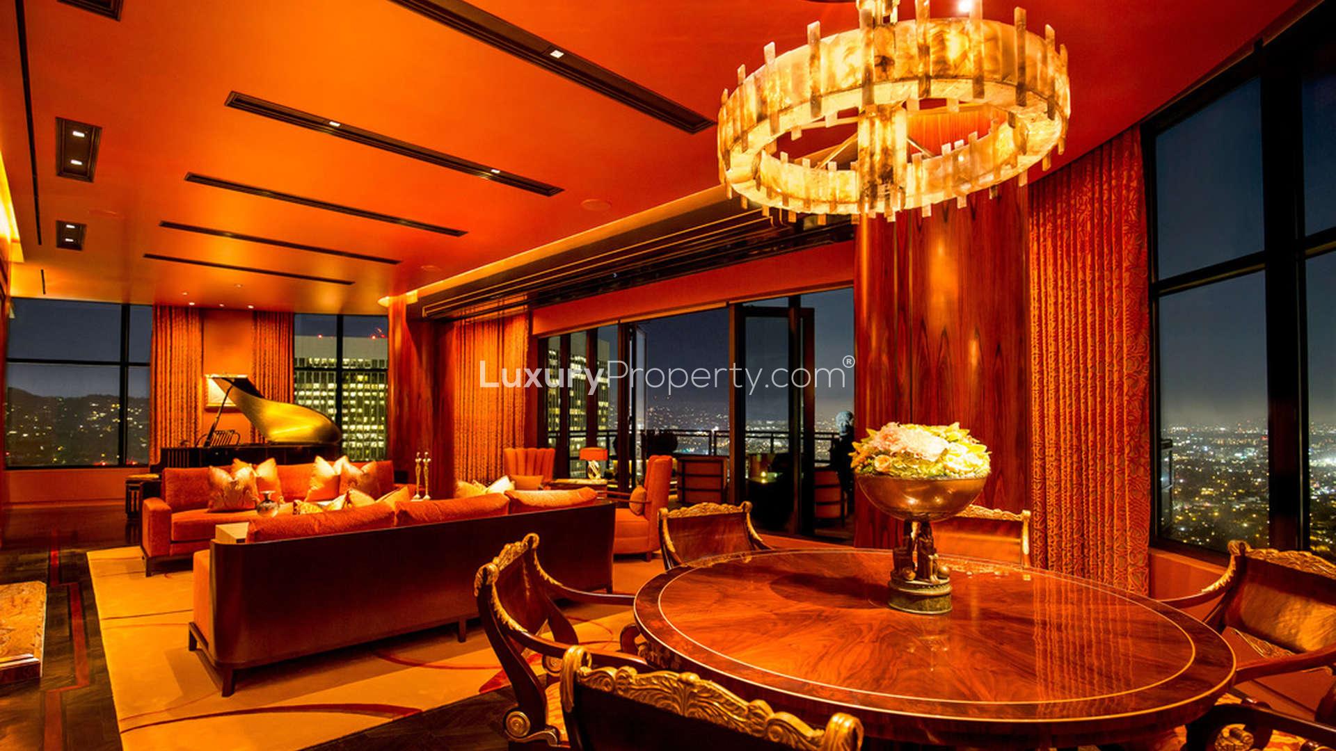 Art Deco penthouse balcony view in Los Angeles at sunset, luxury seating arrangement