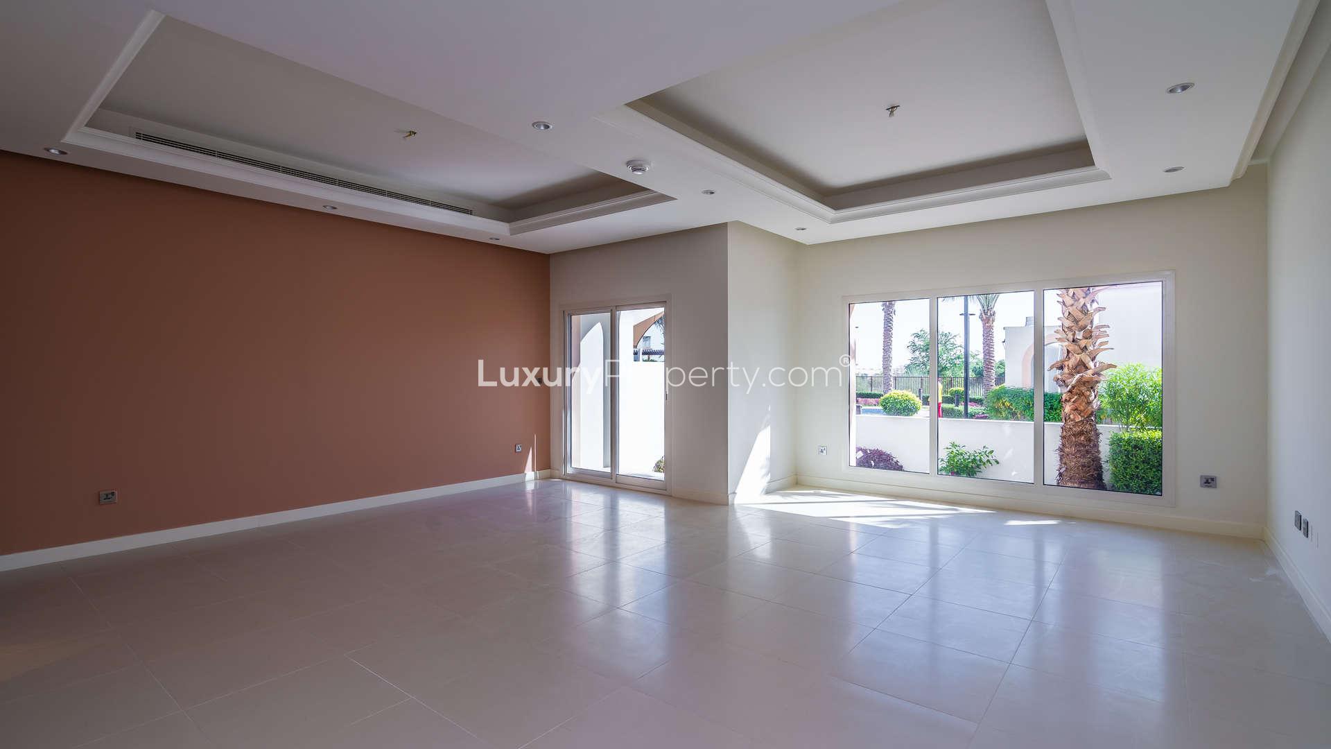 "Bright living room in 3-bedroom villa, Jumeirah Golf Estates, with garden view and modern design.","Spacious living room with large windows in Jumeirah Golf Estates townhouse for sale.","Spacious living room with garden view in Jumeirah Golf Estates townhouse, Fire sub-community.",Modern kitchen in stylish 3-bedroom townhouse, Jumeirah Golf Estates, Fire community, villa for sale