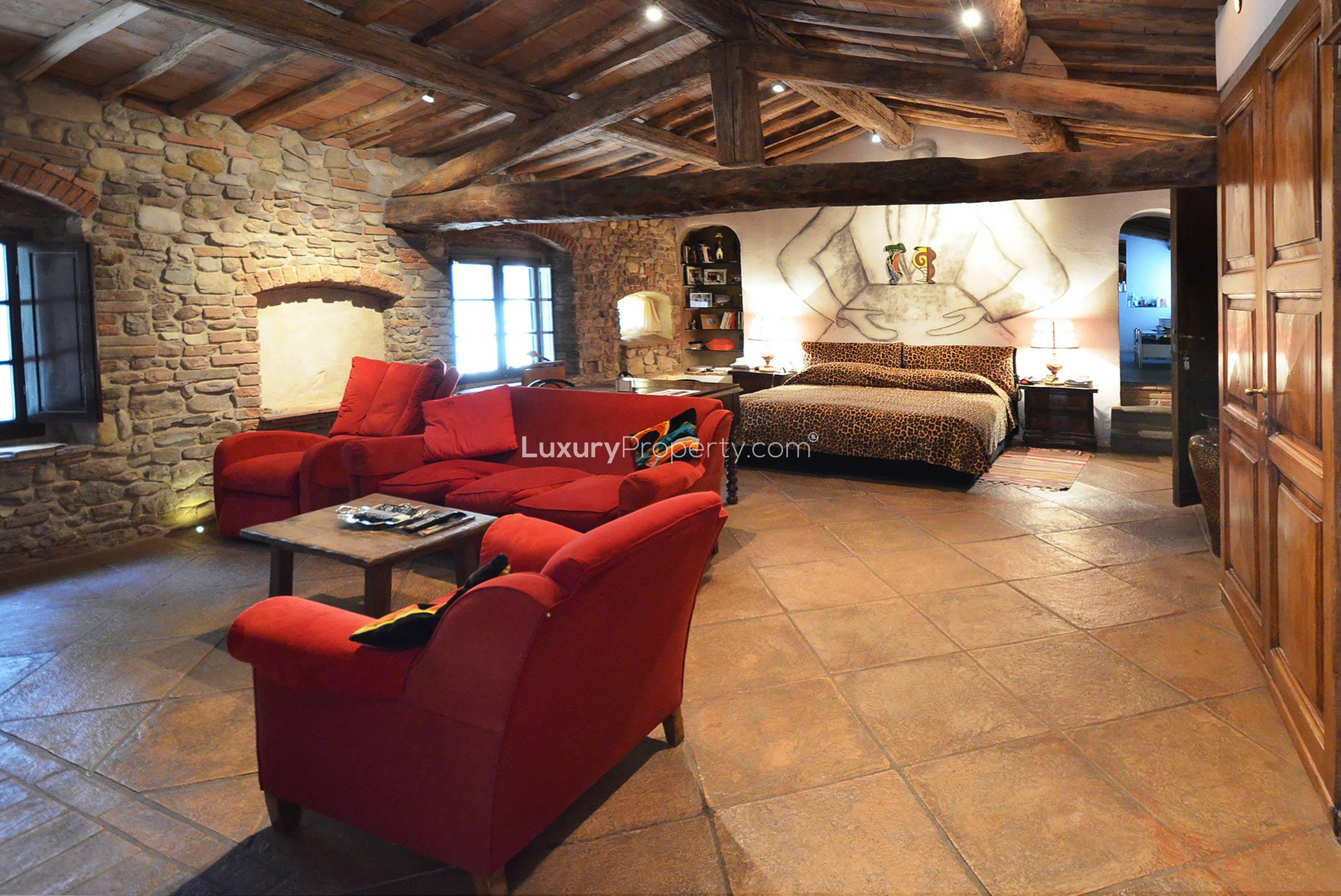 Rustic bedroom with leopard print bedding in Tuscany villa, Fattoria La Corte, Florence
