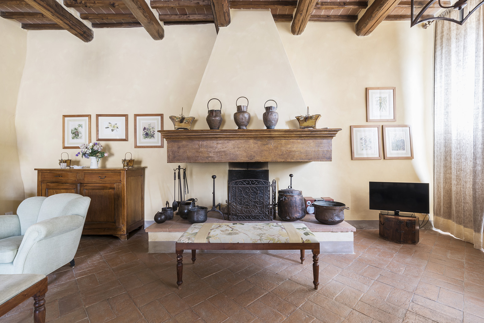 Interior view of charming Chianti villa, featuring rustic bar and cozy seating area
