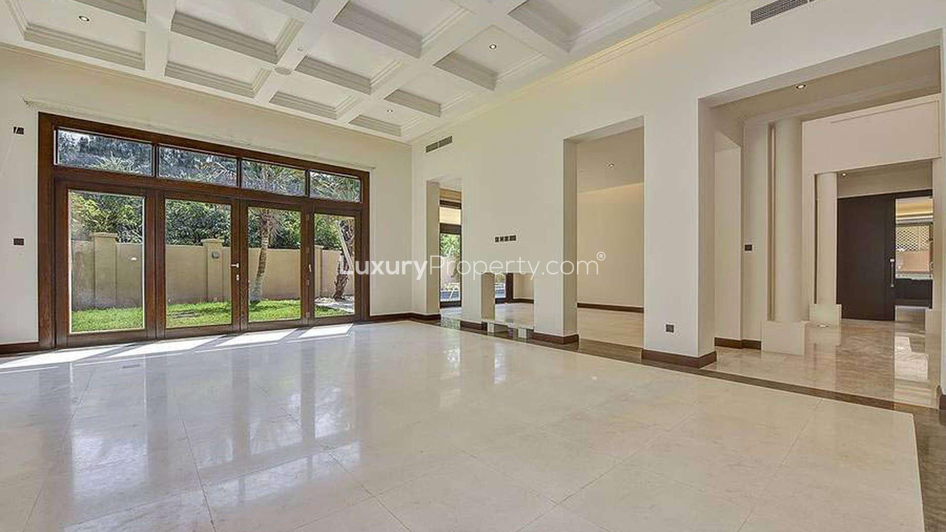 Elegant 6-bedroom villa exterior with lush garden in Bromellia, Al Barari, Dubai for rent