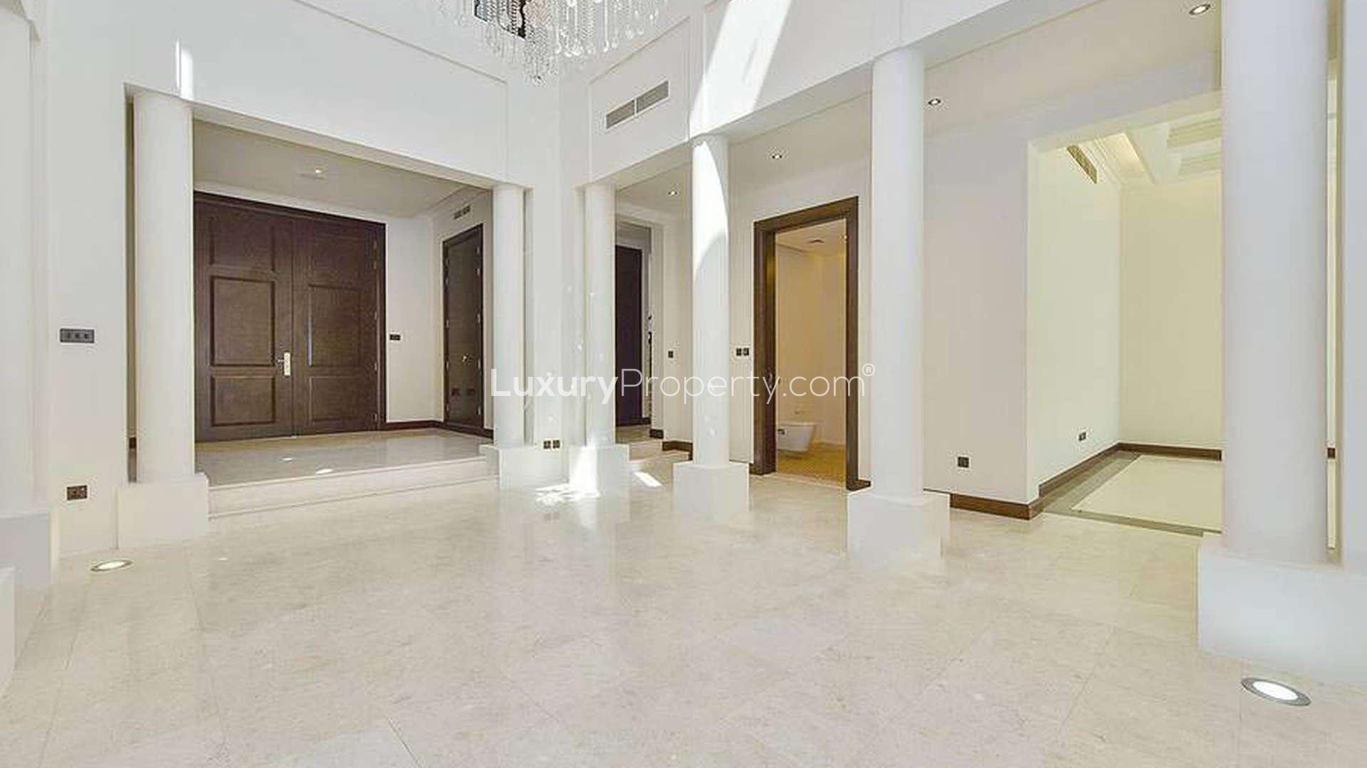 Spacious living room in luxury Al Barari villa, featuring large windows and elegant design