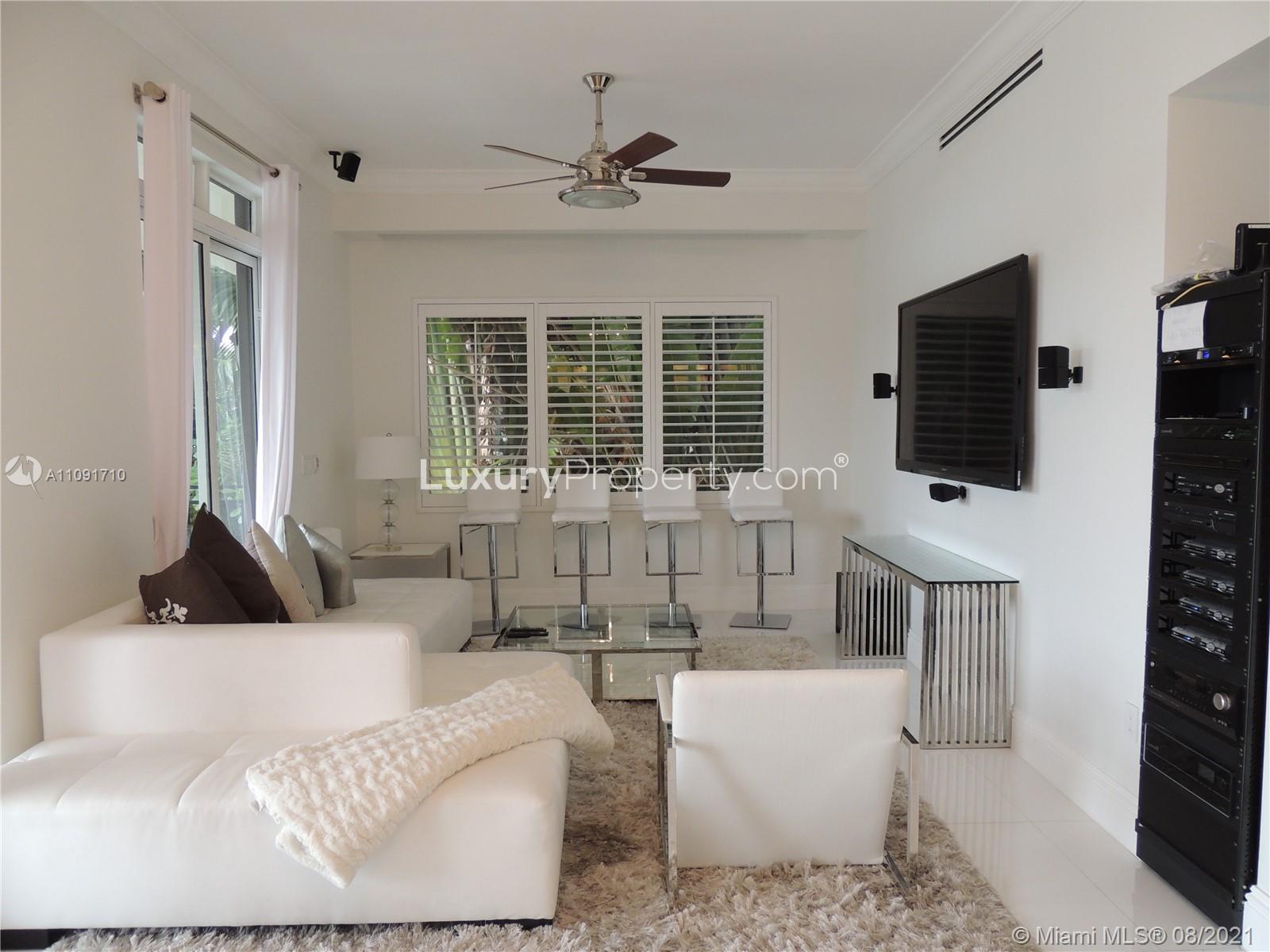 Contemporary Miami Beach villa with poolside loungers on North Hibiscus Drive, for sale