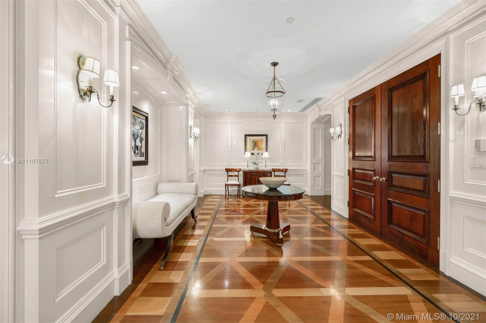 Luxurious Miami penthouse at 445 Grand Bay Dr, surrounded by lush greenery and pool