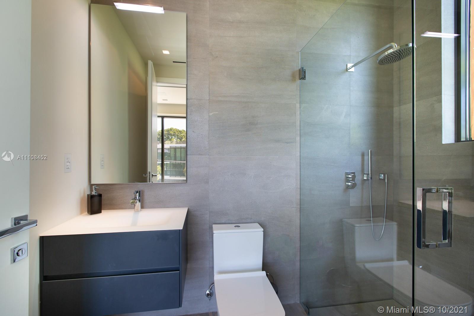 Luxurious Miami waterfront villa with pool, modern design, lush greenery, and spacious patio