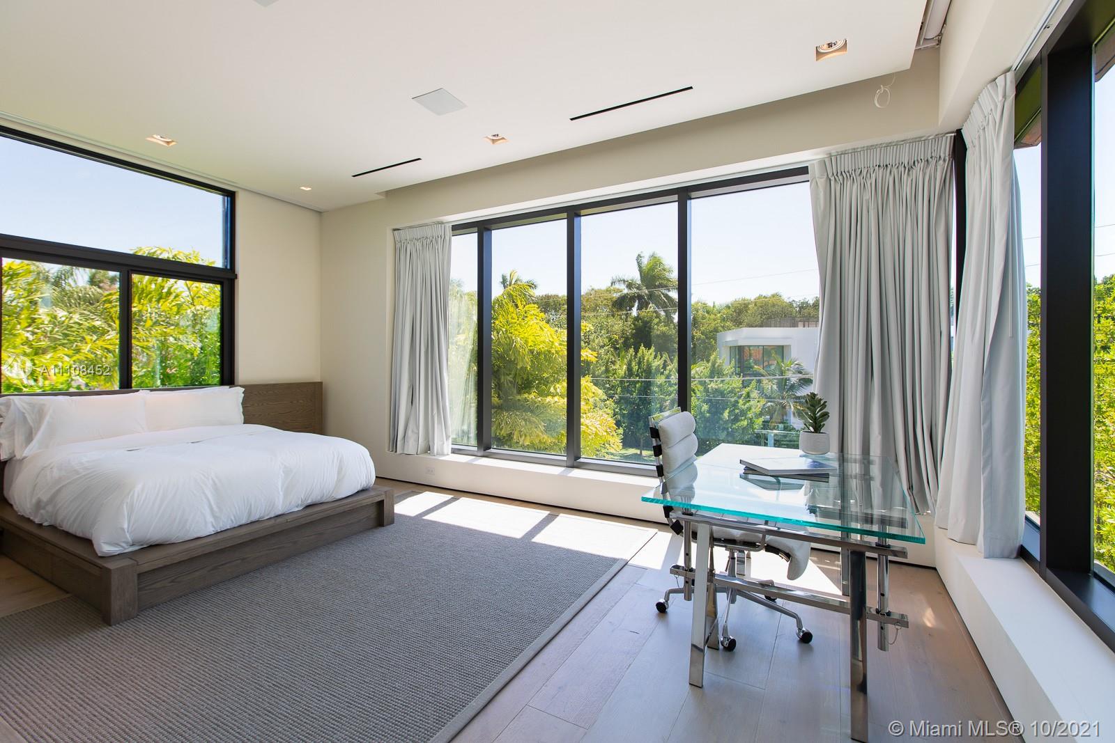 Modern bathroom in Miami villa at 421 N Hibiscus Dr, featuring sleek fixtures and glass shower