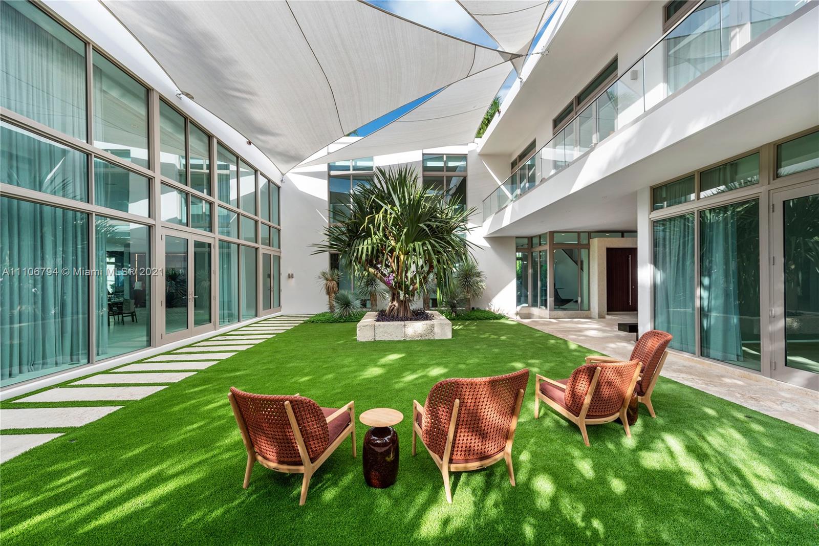 Infinity pool with palm trees and ocean view at Miami villa for sale