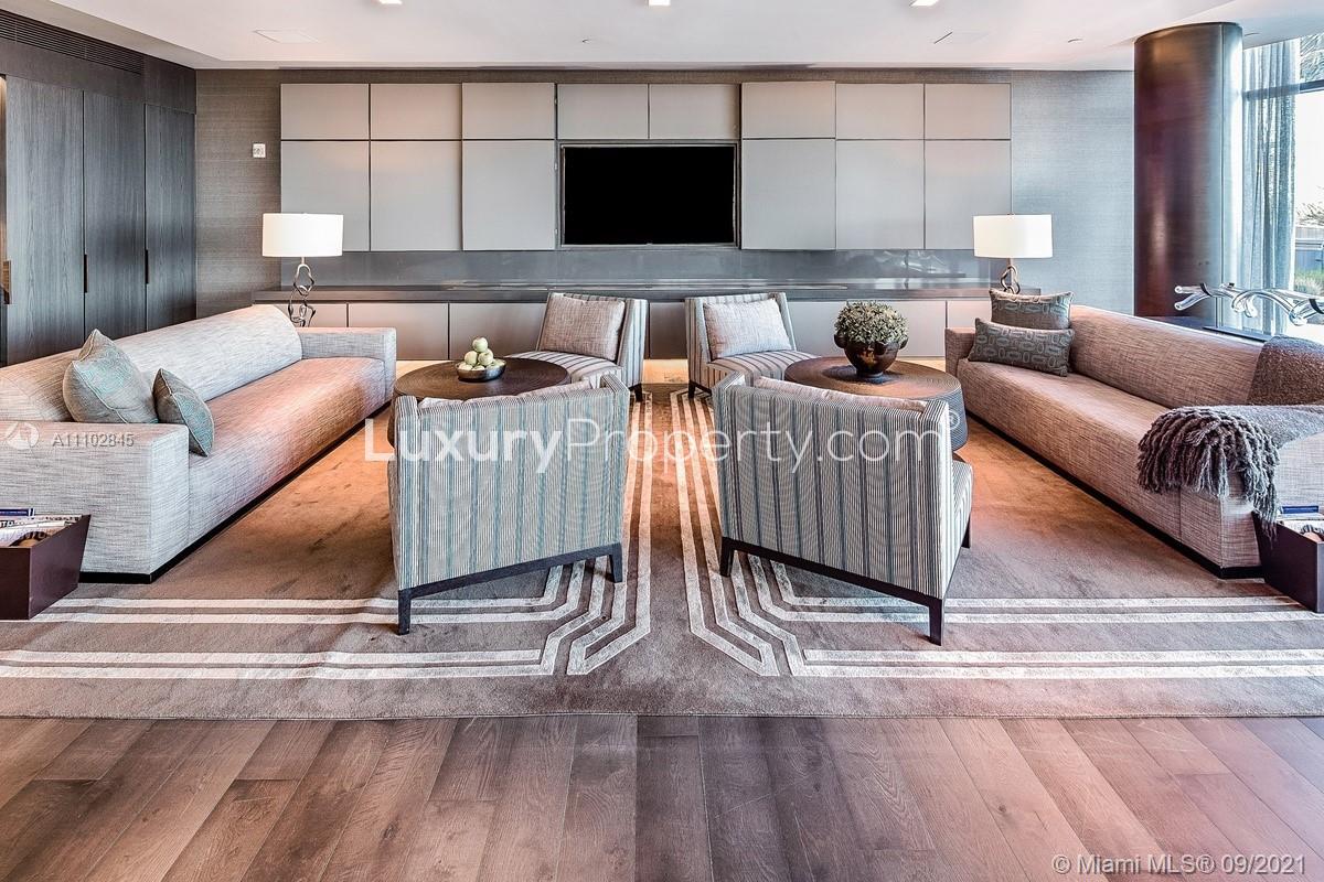 Luxurious Miami villa living room with ocean views, modern decor, and floor-to-ceiling windows