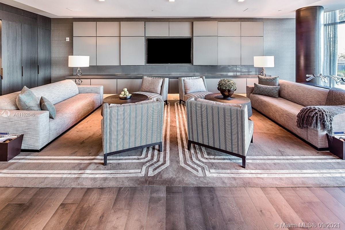 Luxurious Miami villa living room with ocean views, modern decor, and floor-to-ceiling windows