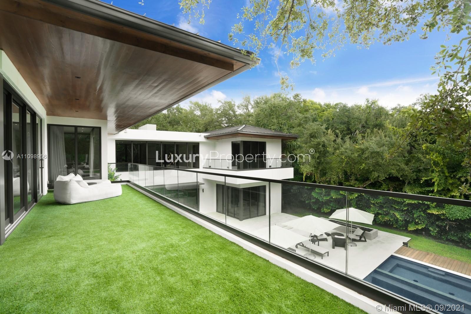 Luxurious poolside patio at villa for sale, 5400 Hammock Dr, Coral Gables, Miami