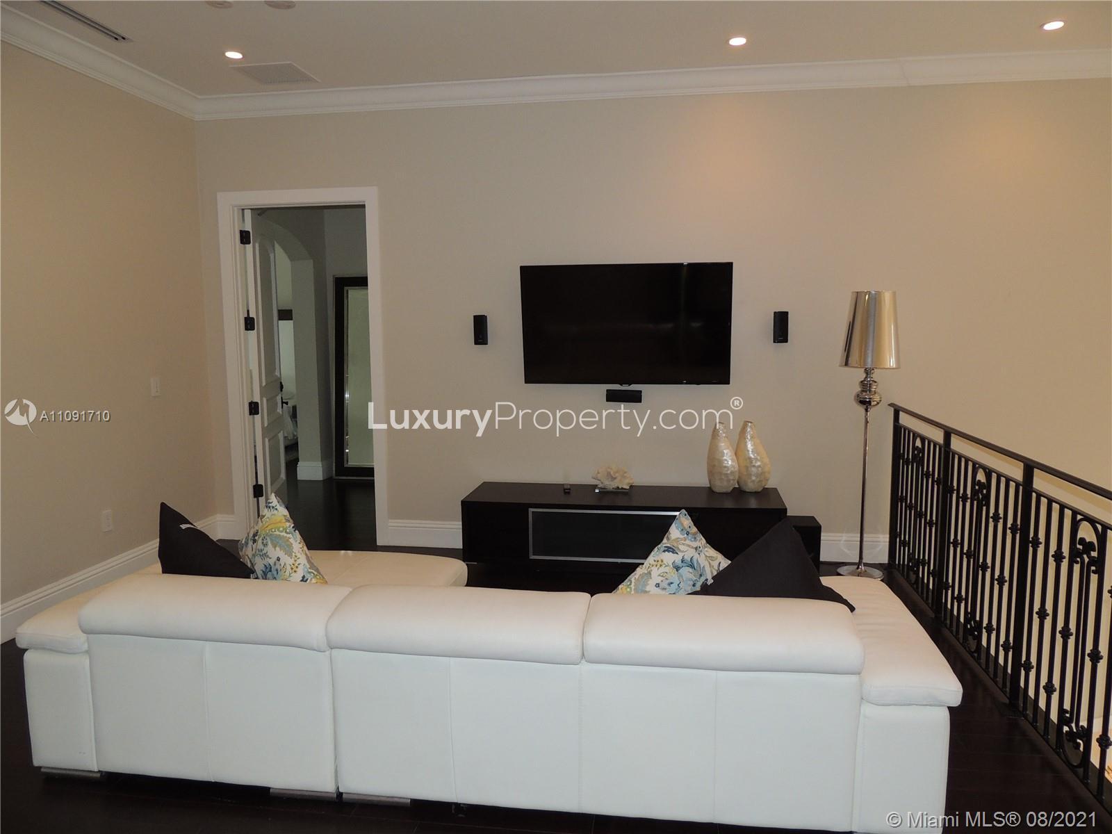 Dining room with modern white table and chairs in Miami Beach villa, Hibiscus Island