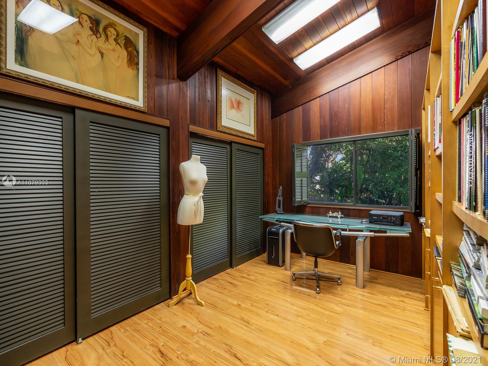 Luxurious Miami Beach villa with pool, lush greenery, and outdoor seating at N Kendall Drive