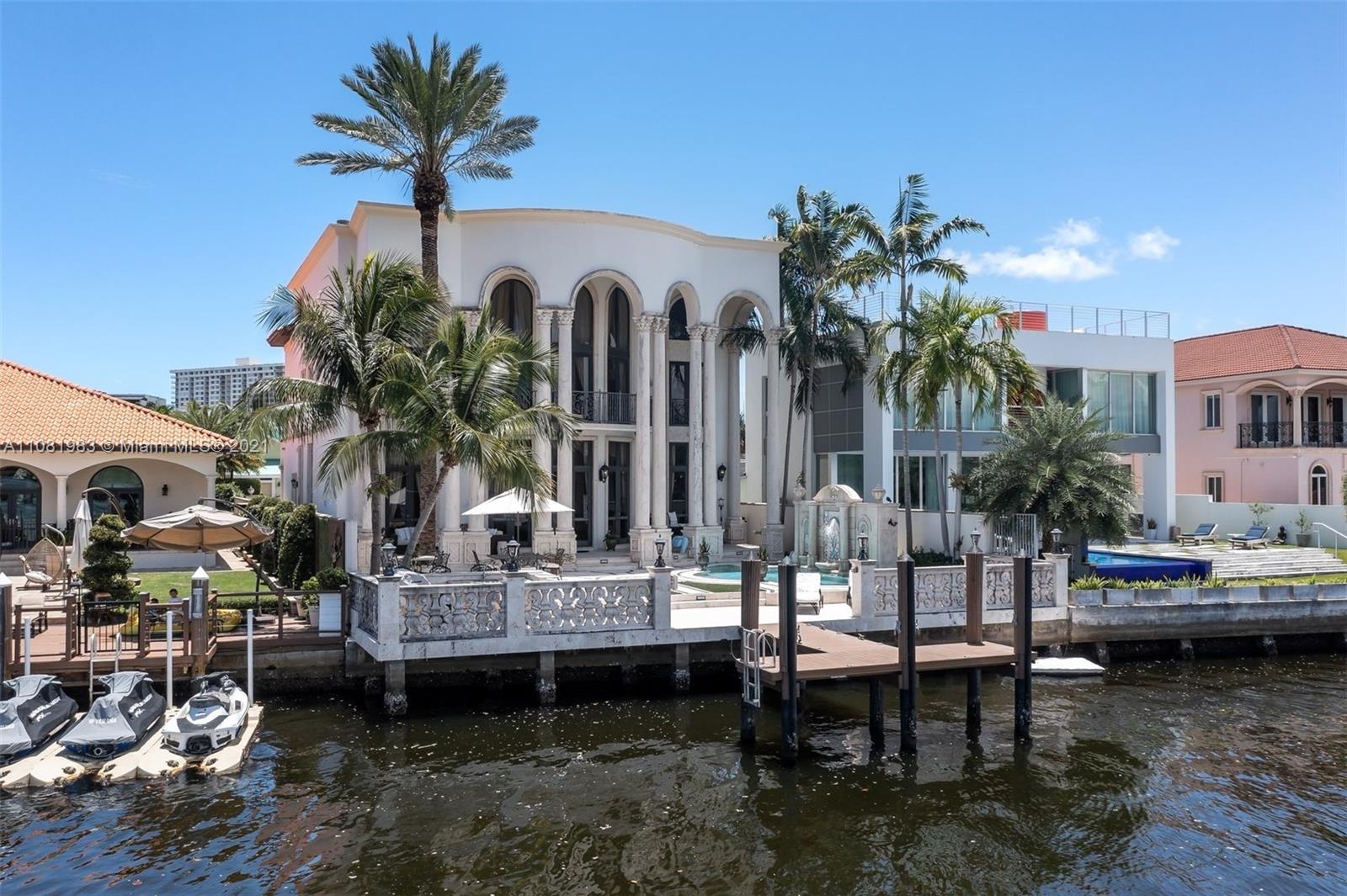 Aerial view of luxury villa with pool and dock in Miami, Florida
