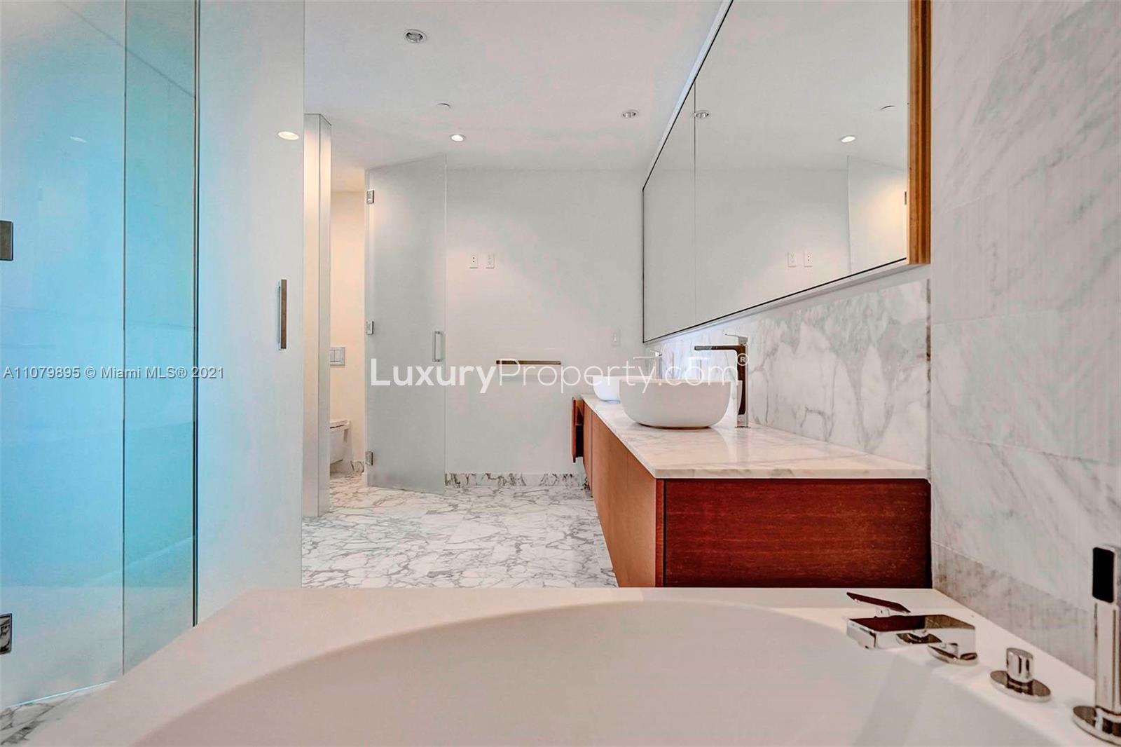 Luxurious bathroom in high-floor Bal Harbour condo, featuring marble design and modern fixtures